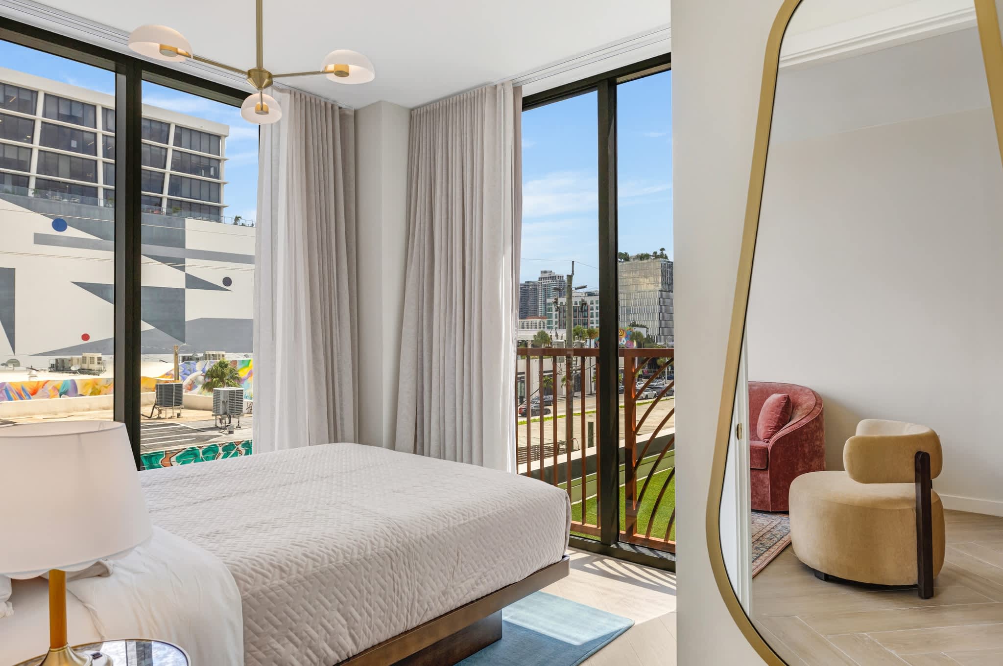 Relax in this stylish bedroom with stunning city views and chic decor, perfect for unwinding after a day of exploring.