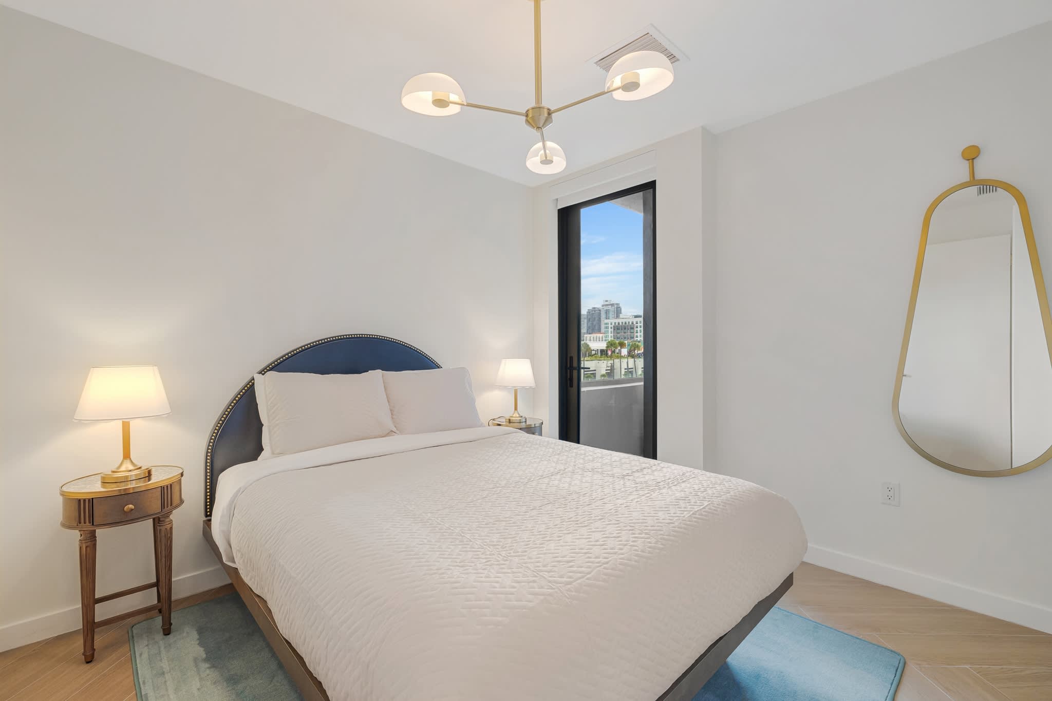 Relax in this bright and stylish bedroom with city views and modern decor, perfect for a restful stay.