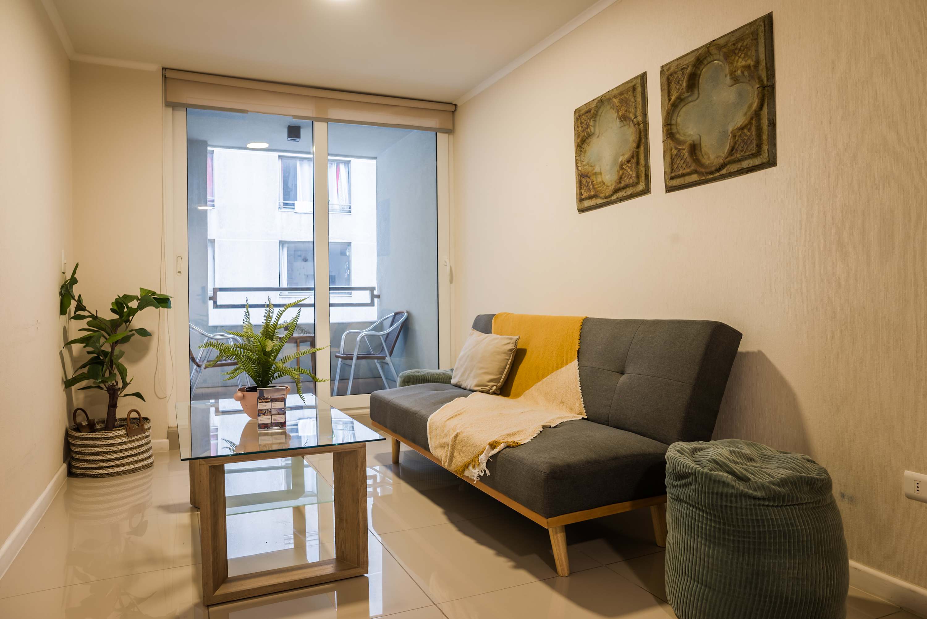 Cozy living area with balcony access, perfect for relaxing after exploring the city.