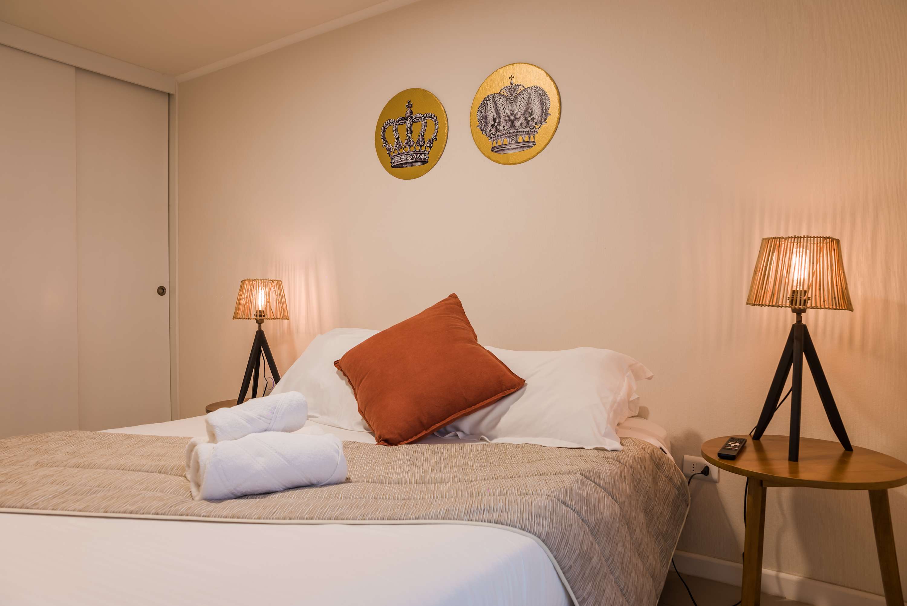 Relax in this cozy bedroom with stylish decor and ambient lighting, perfect for a restful stay.