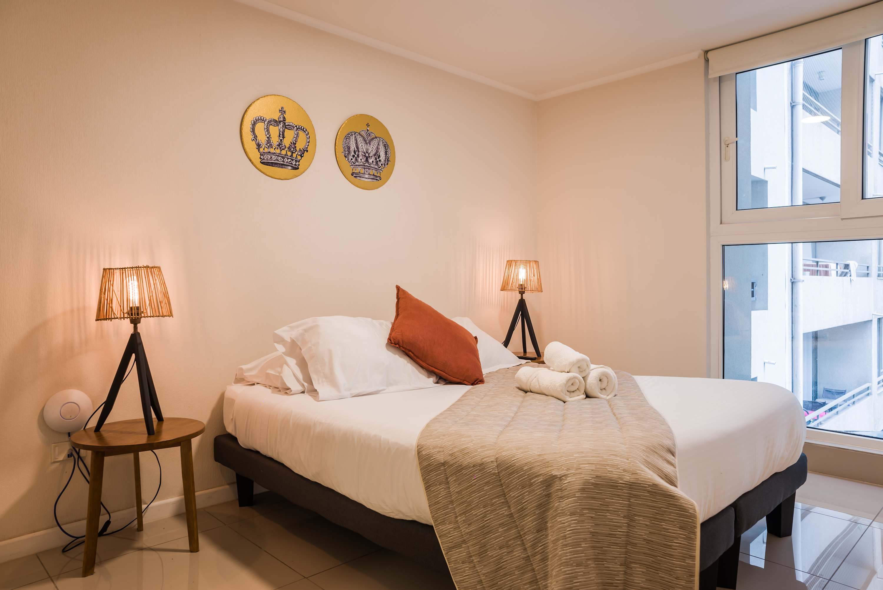 Relax in this cozy bedroom with stylish decor and ample natural light, perfect for a restful stay.