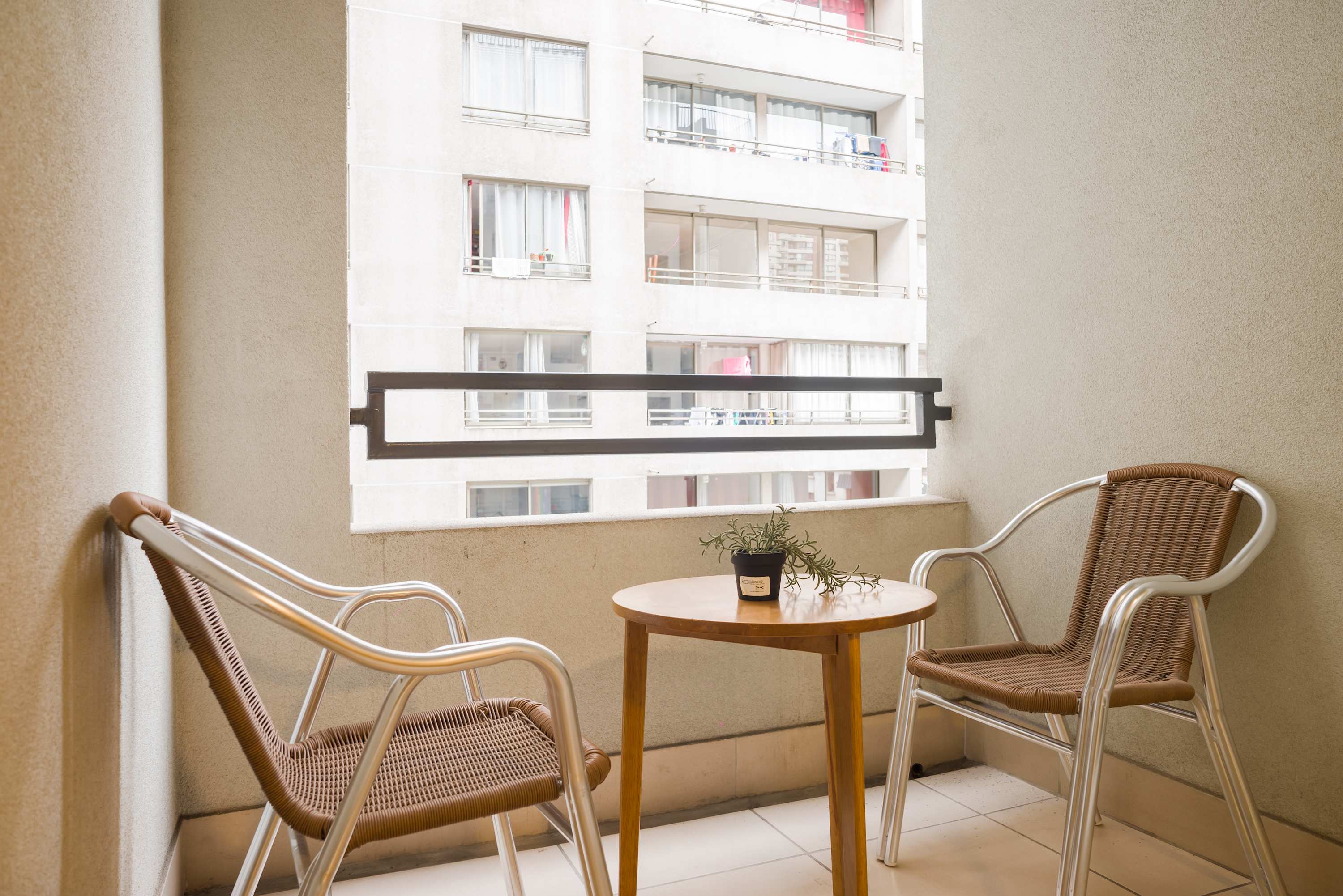 Cozy private balcony perfect for morning coffee or evening relaxation, with a charming urban view.