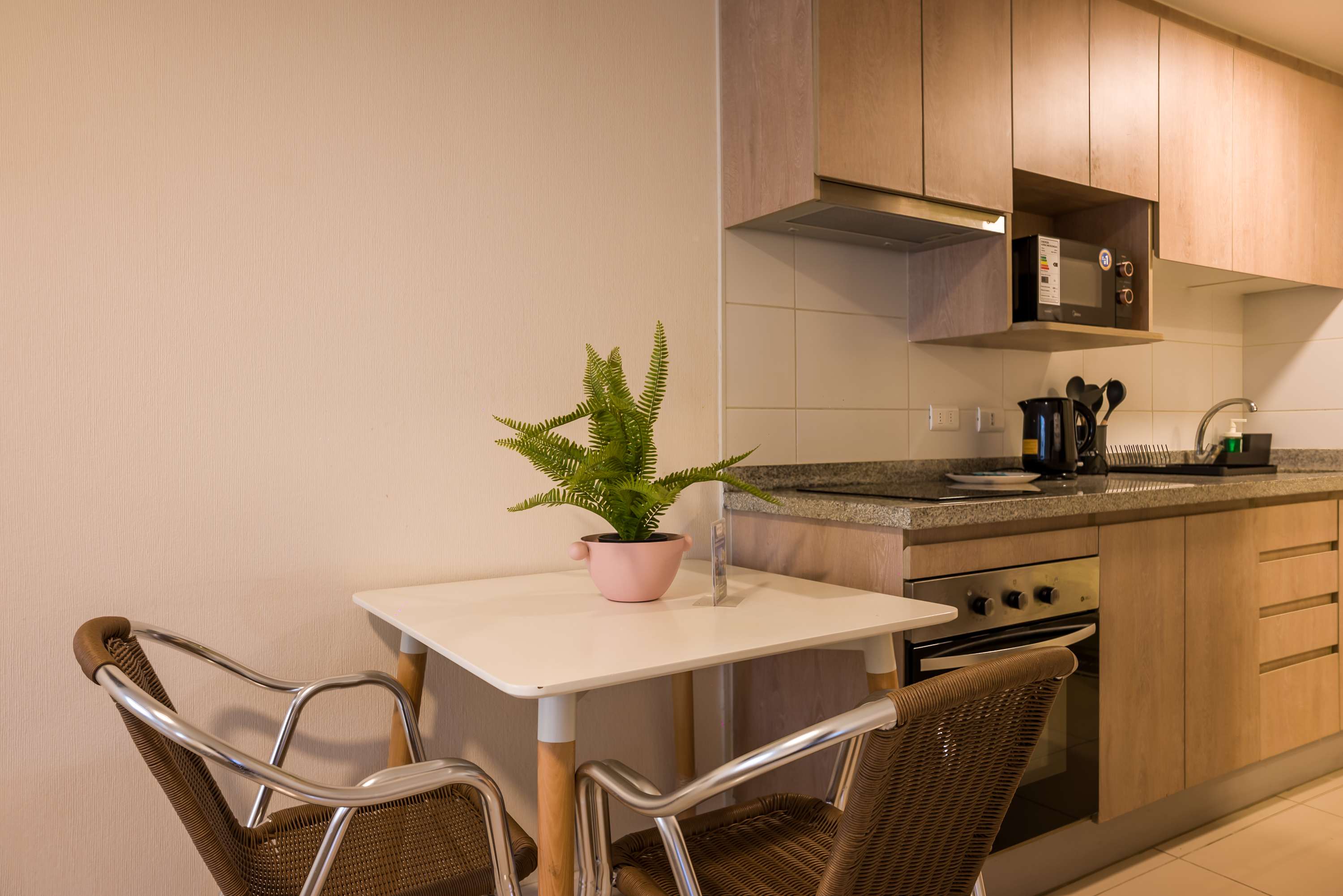 Cozy kitchen with modern amenities and a charming dining nook, perfect for intimate meals.