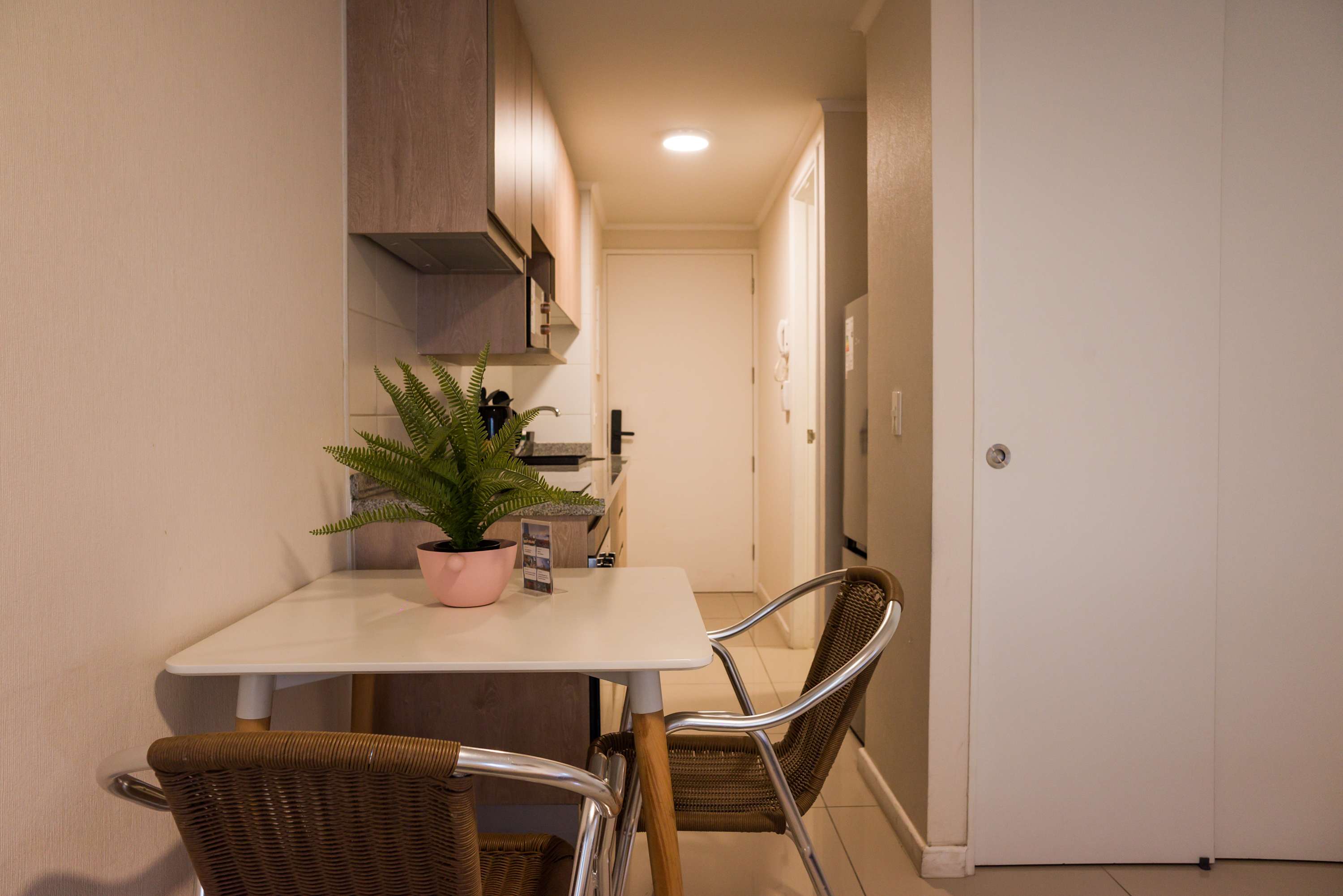 Cozy kitchen nook perfect for intimate meals, featuring modern cabinetry and a charming dining setup.