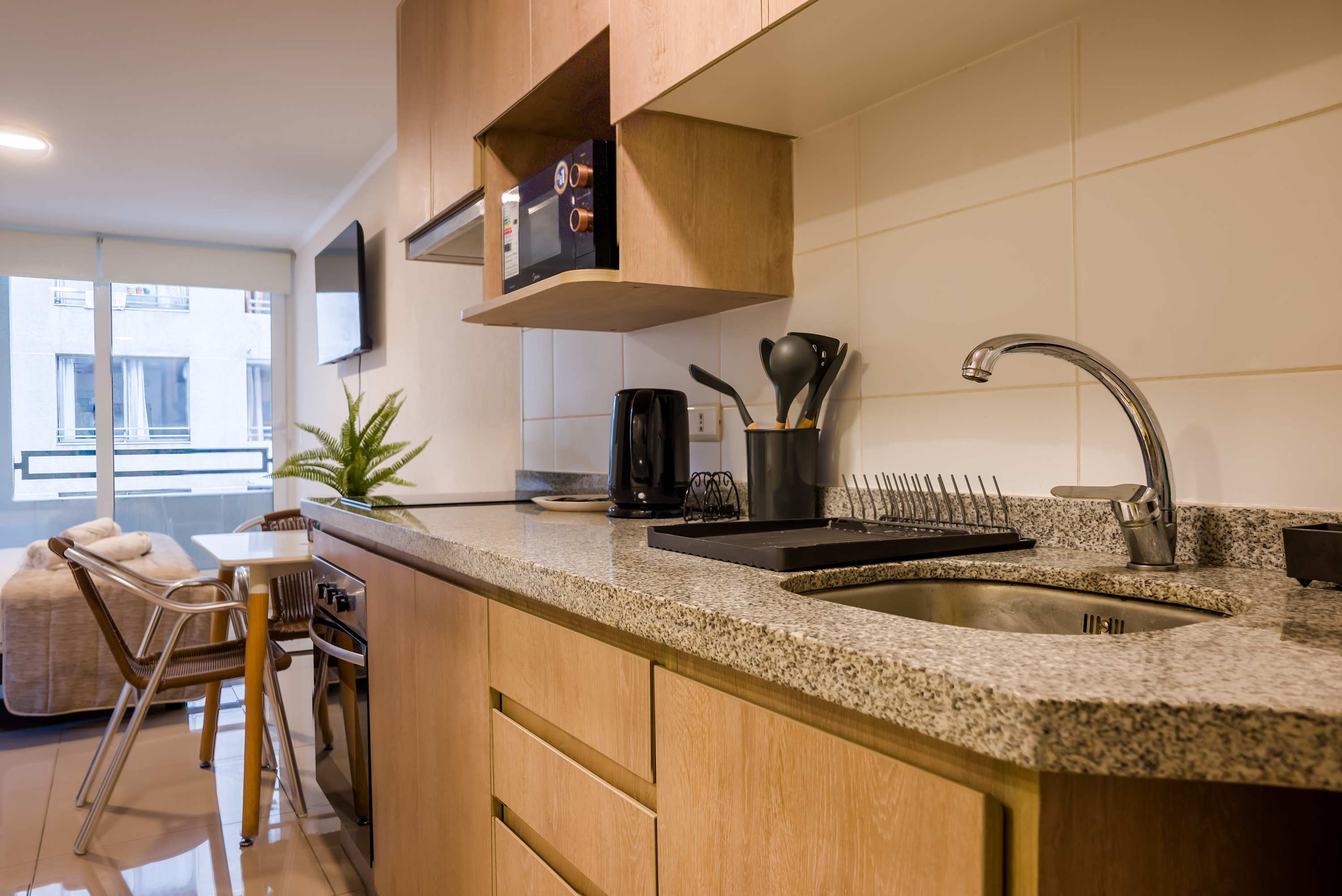 Cozy kitchen with modern amenities and a bright dining area, perfect for a comfortable stay.