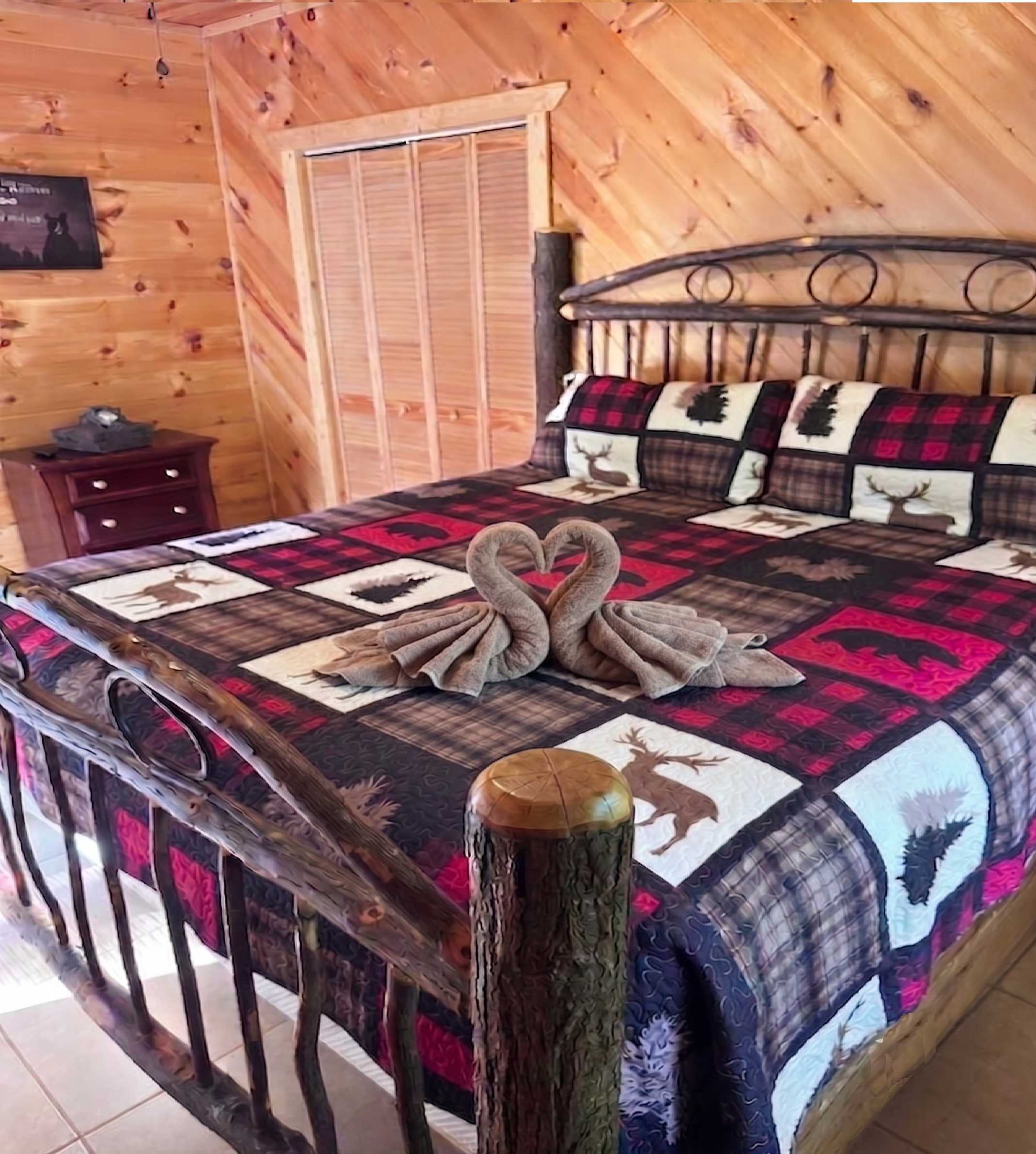 A fresh view of Bedroom 4 offering comfort, warmth, and peaceful cabin charm.