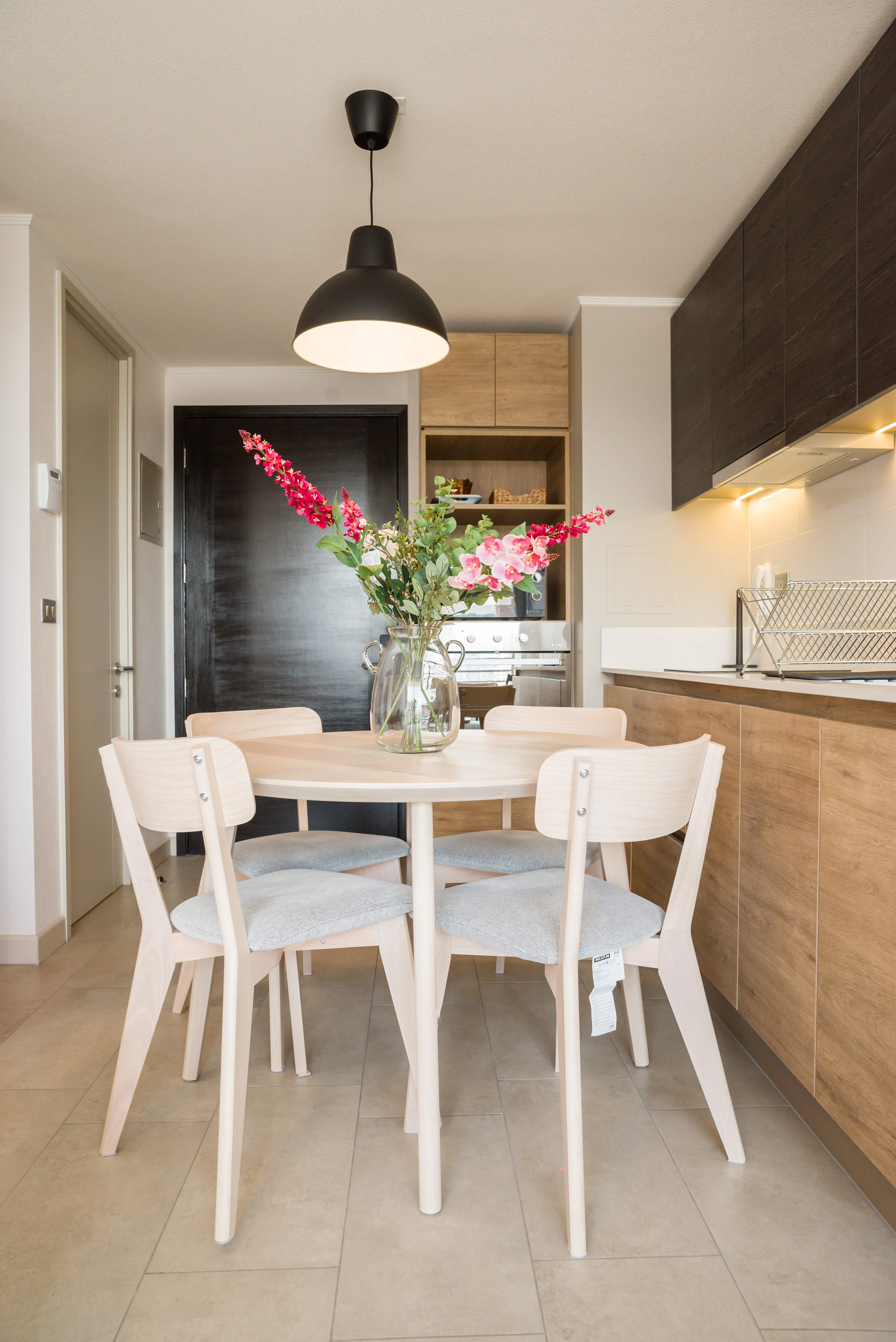Cozy dining area with modern kitchen, perfect for intimate meals and gatherings.