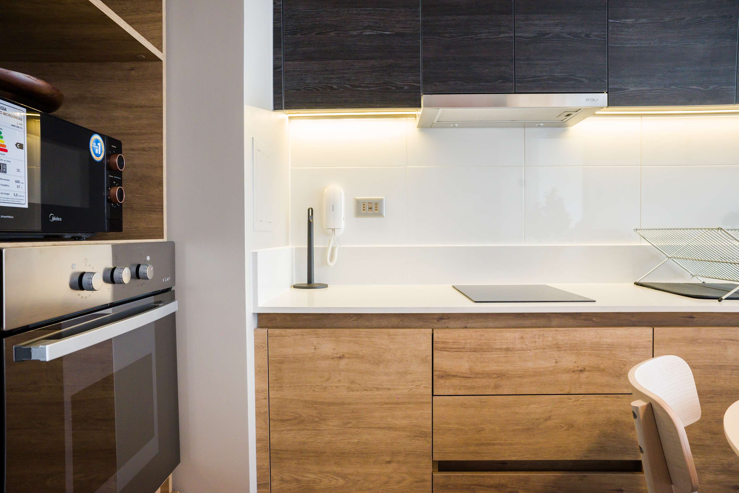 Sleek and modern kitchen with top-notch appliances and ample storage, perfect for cooking your favorite meals.