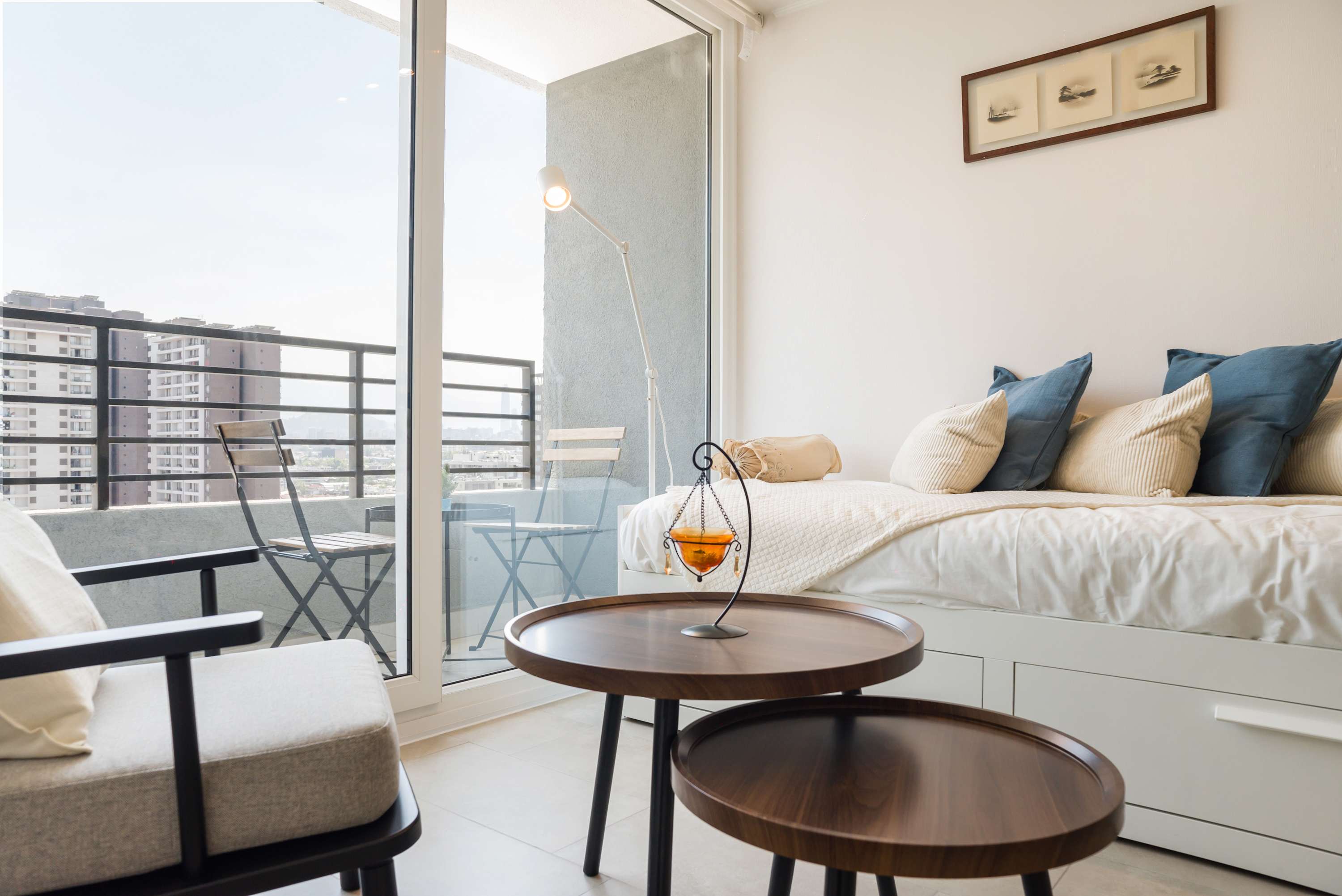 Relax in this cozy living area with a city-view balcony, perfect for enjoying a morning coffee or evening breeze.