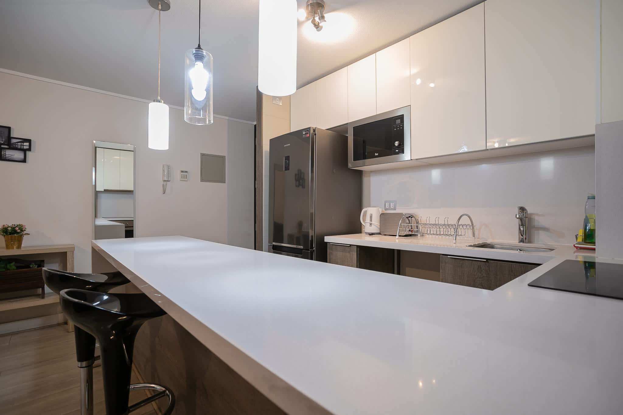 Sleek and modern kitchen with bar seating, perfect for casual dining and entertaining.
