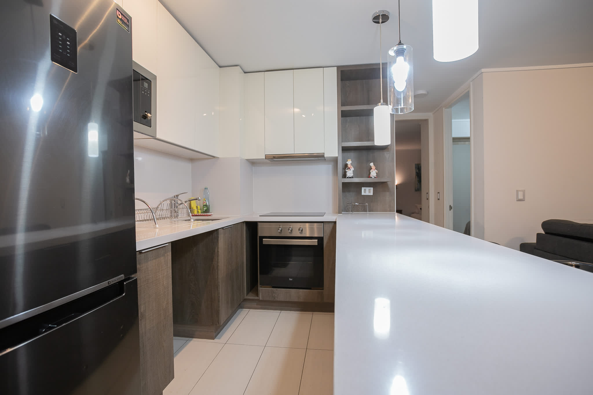 Experience culinary delight in this sleek, modern kitchen with top-notch appliances and ample counter space.
