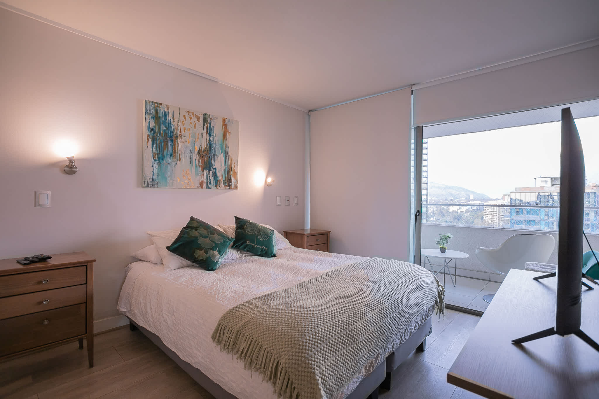 Relax in this cozy bedroom with a stunning city and mountain view from the balcony.