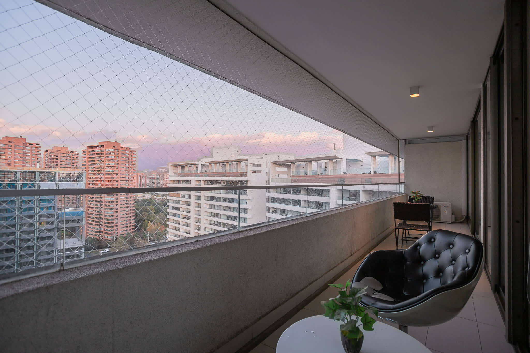 Relax on the private balcony with stunning city and mountain views, perfect for unwinding after a day of exploring.
