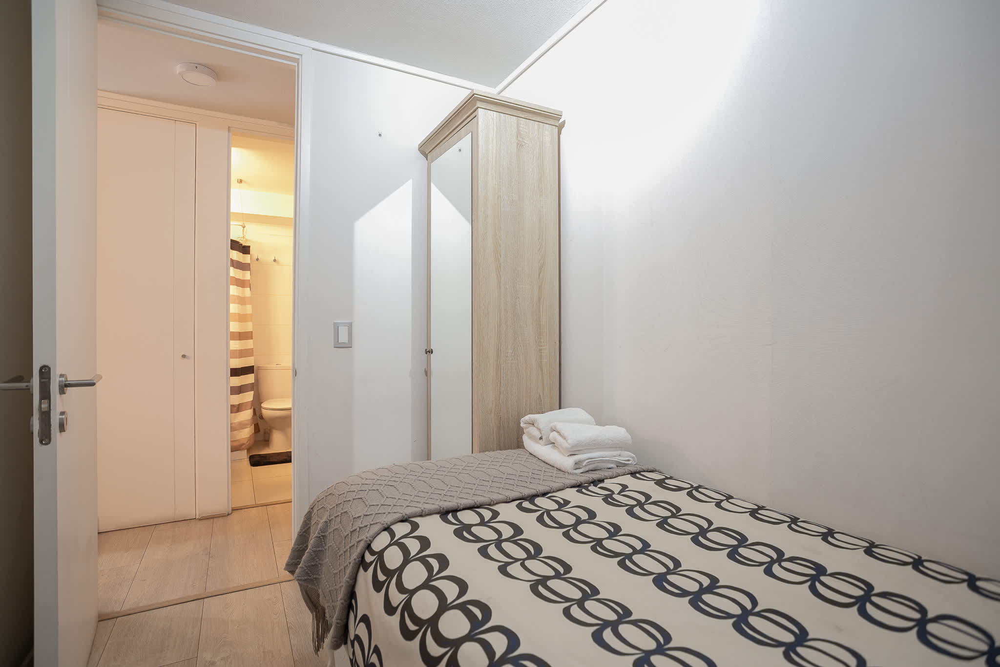 Cozy bedroom with convenient access to a private bathroom, perfect for a restful stay.