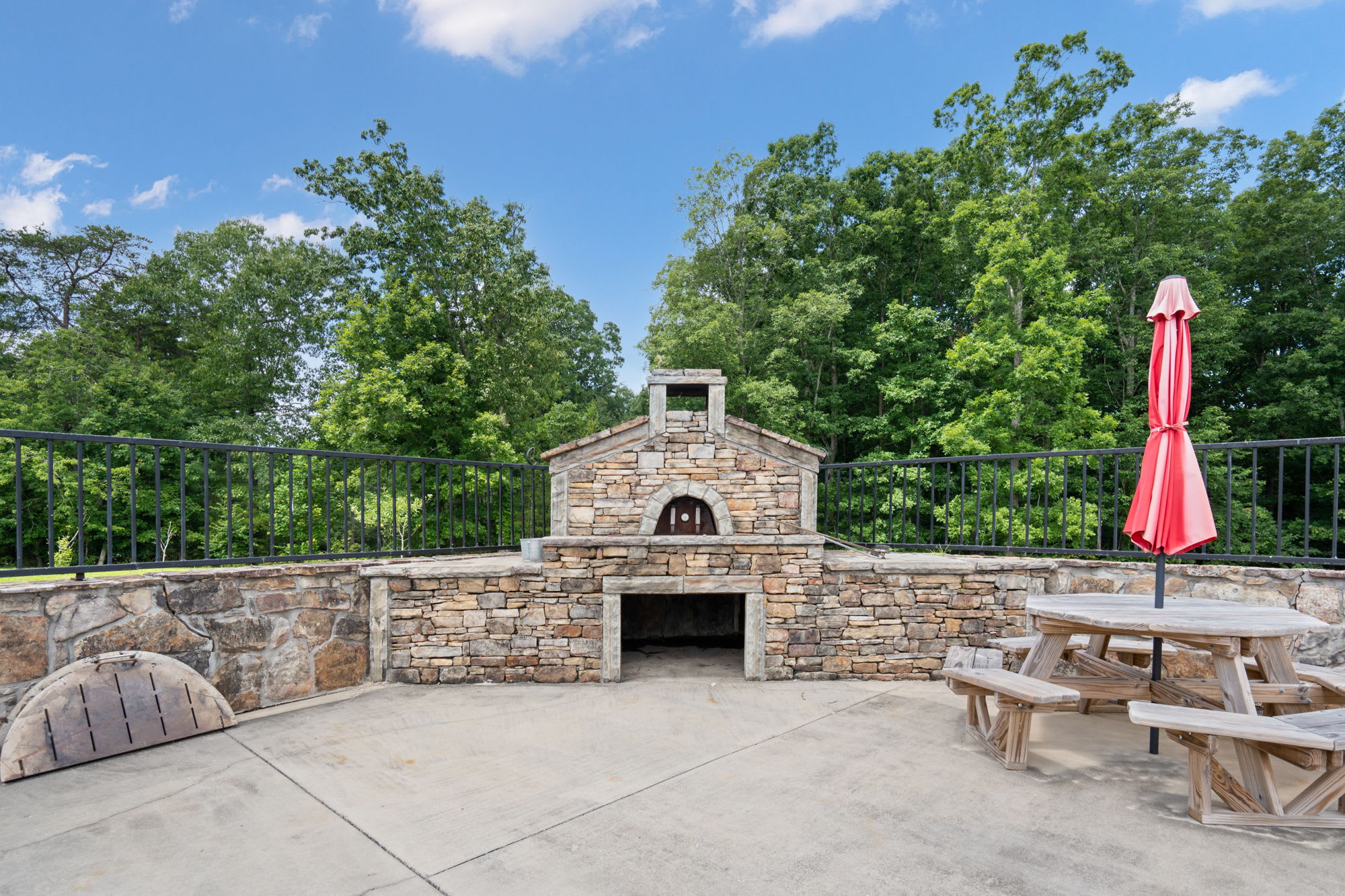 Pizza oven at our pool with outdoor seating