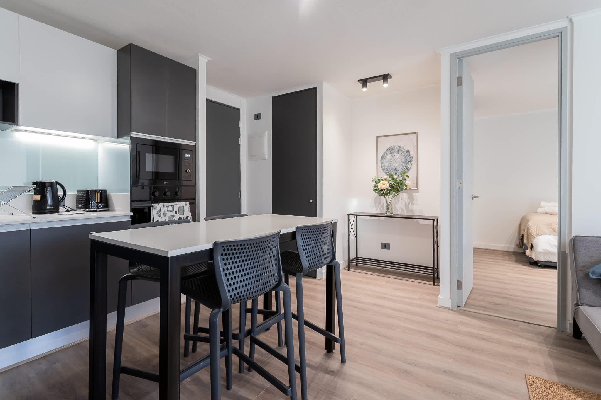 Modern kitchen and dining area with sleek design and ample seating, perfect for cozy meals.