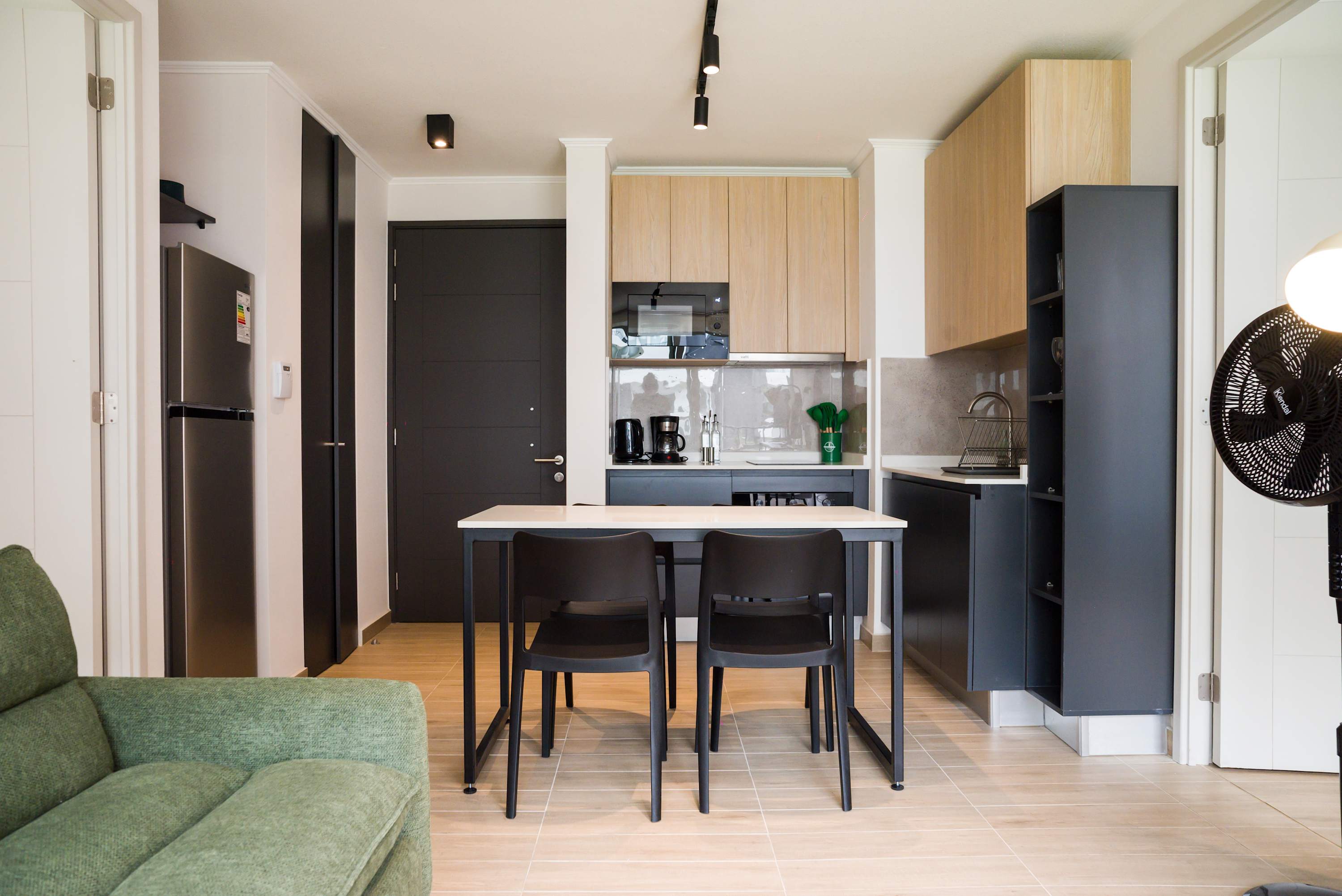 Modern kitchen with sleek appliances and cozy dining area, perfect for intimate meals.