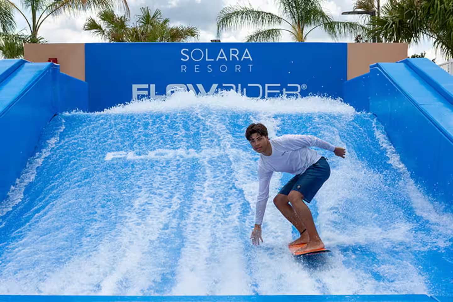 Experience the thrill of surfing on the FlowRider at Solara Resort, perfect for adventure seekers!