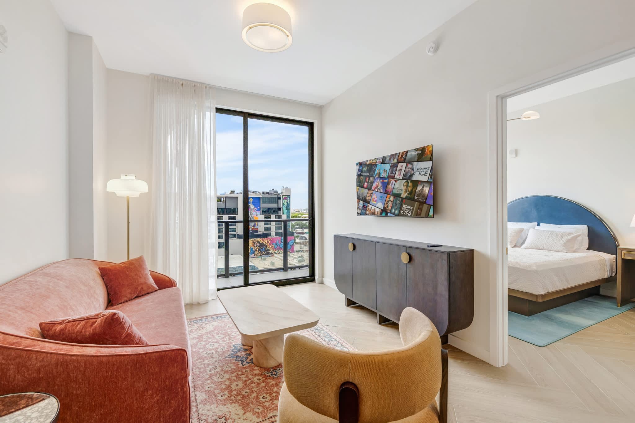 Relax in this chic living room with city views, modern decor, and cozy seating, perfect for unwinding after a day of exploring.