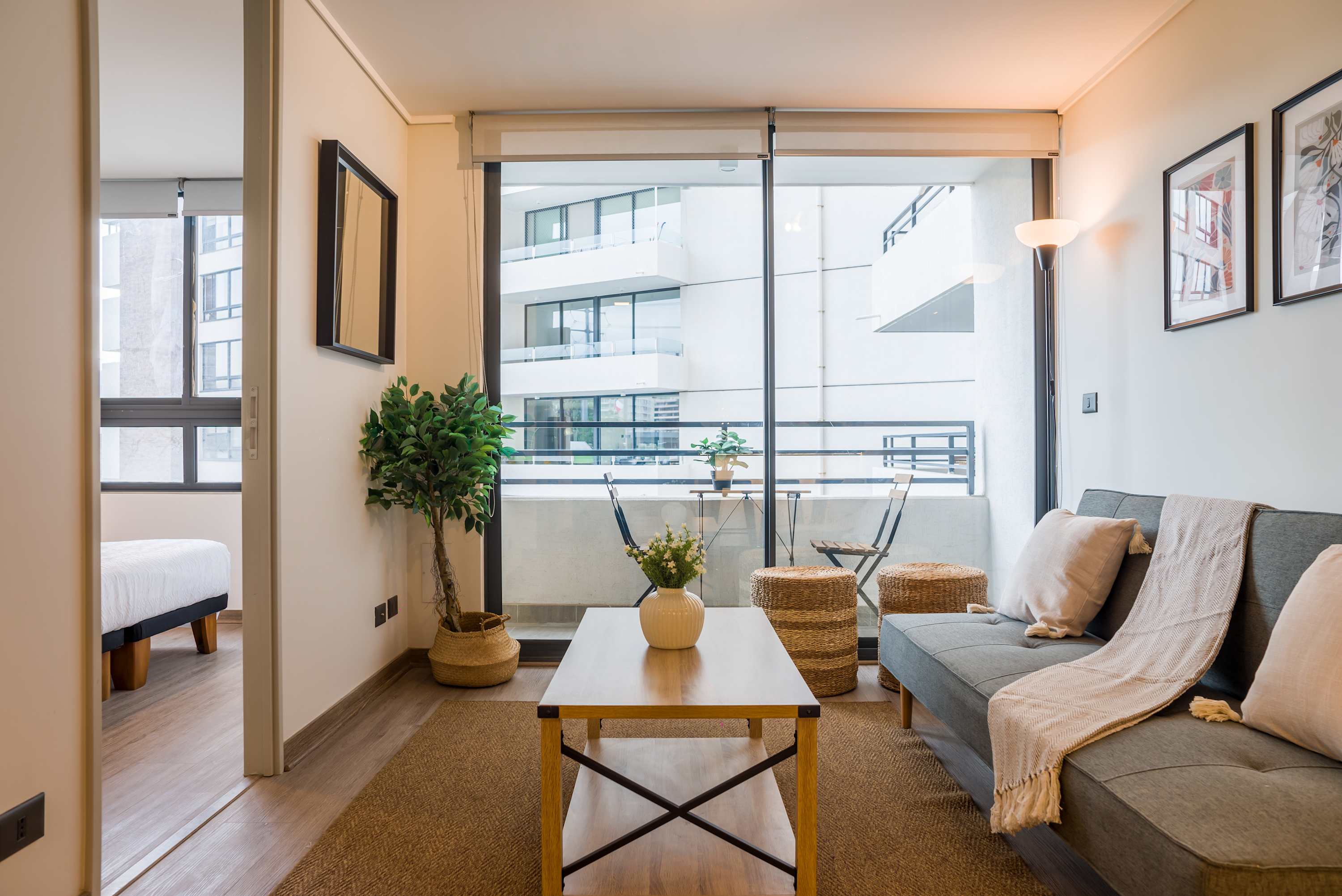 Bright and cozy living area with access to a private balcony, perfect for relaxing and enjoying the city view.