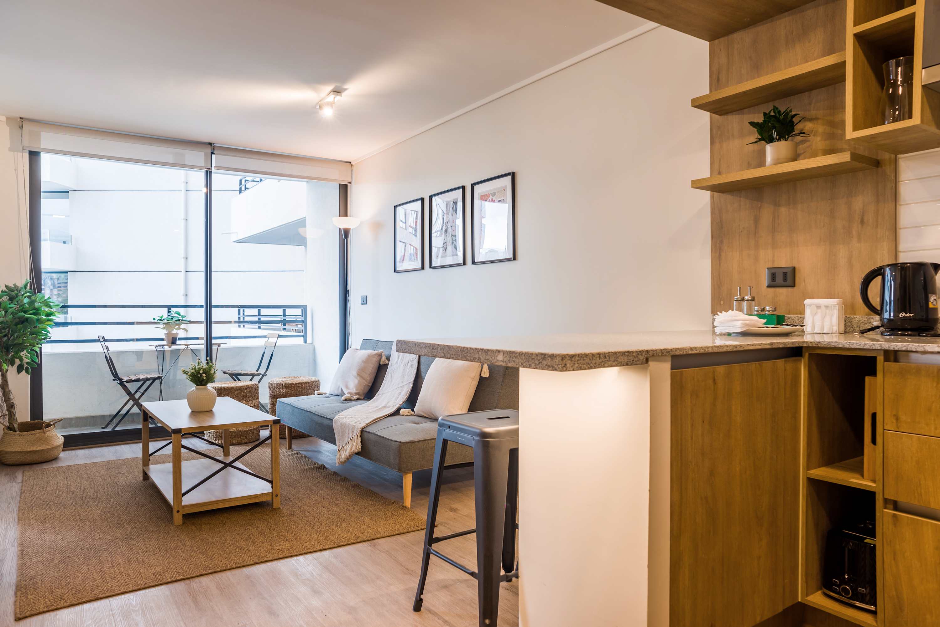 Bright and cozy living space with balcony access, perfect for relaxation and enjoying city views.