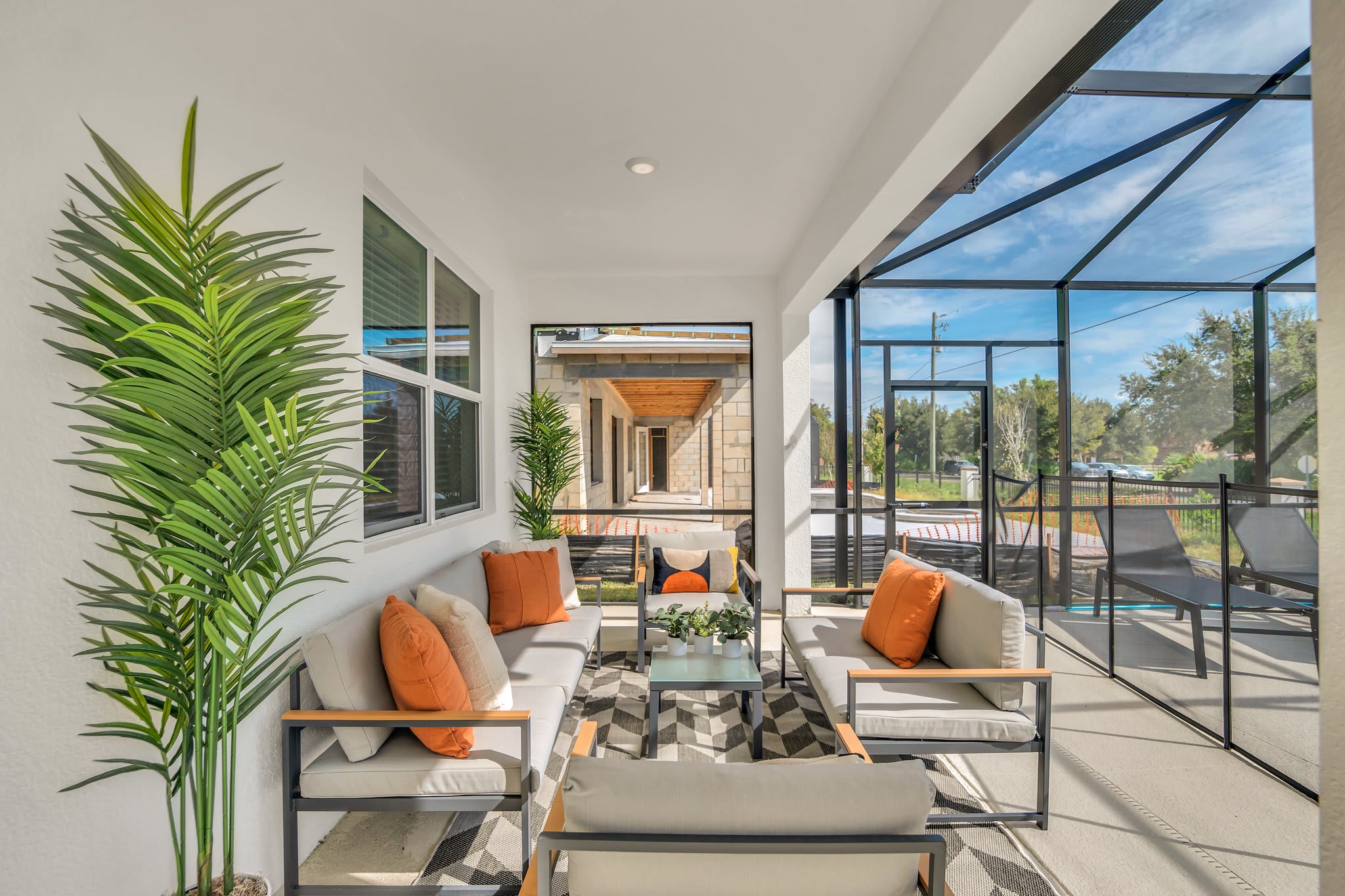 Relax in style on this modern patio with plush seating and vibrant decor, perfect for enjoying the outdoors.