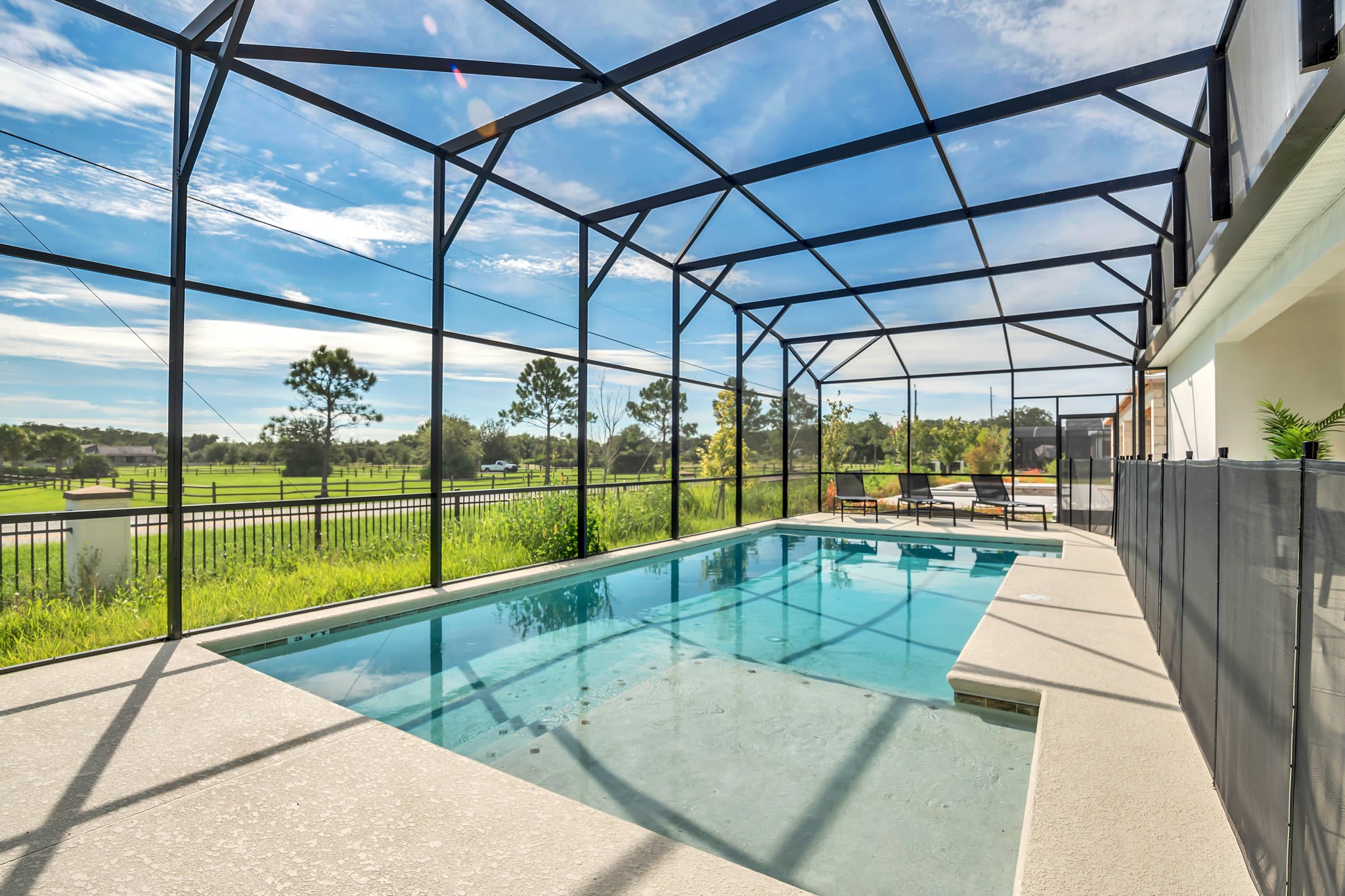Enjoy a refreshing swim in your private screened-in pool with scenic views and ample lounging space.