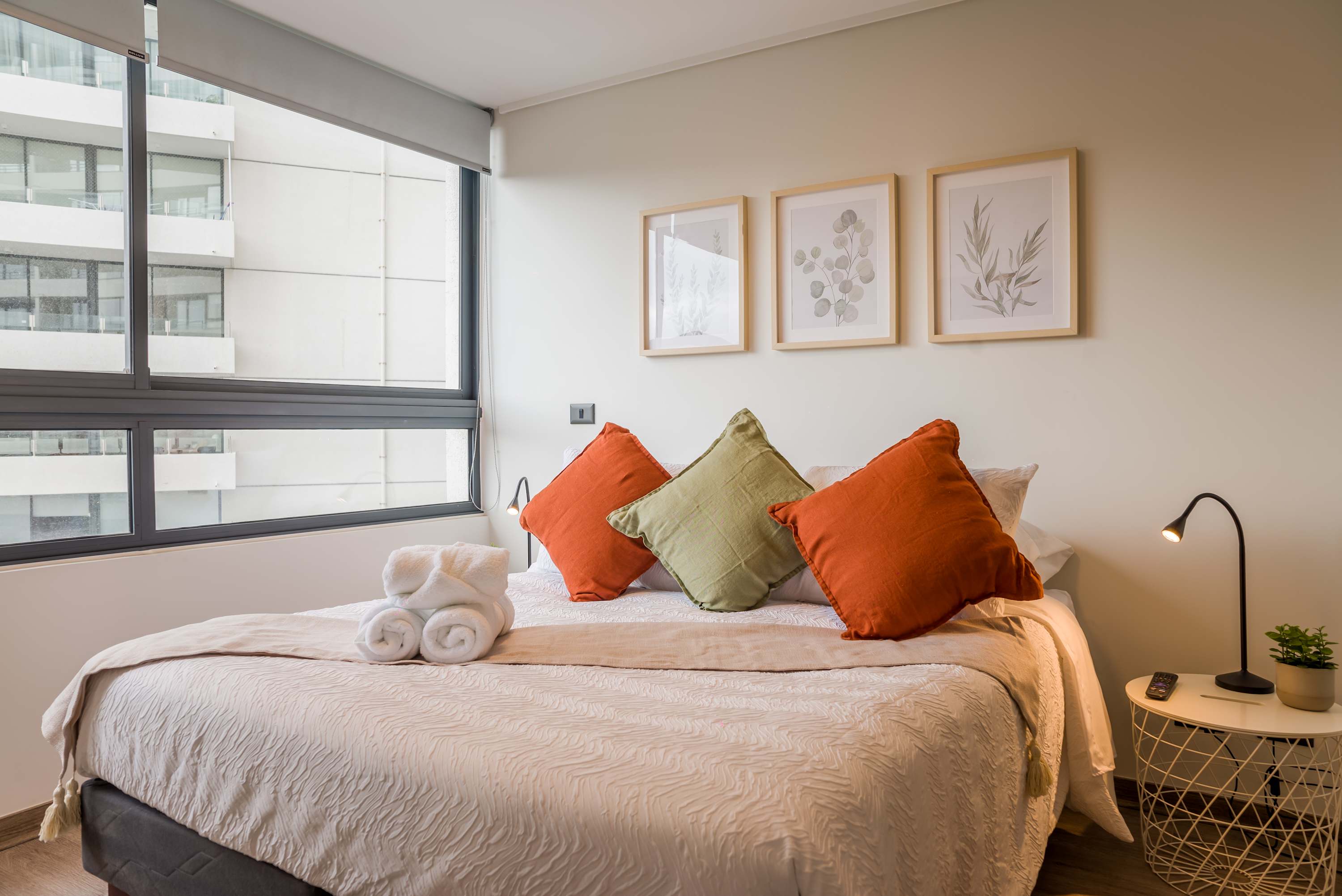 Relax in this bright and cozy bedroom with modern decor and ample natural light.