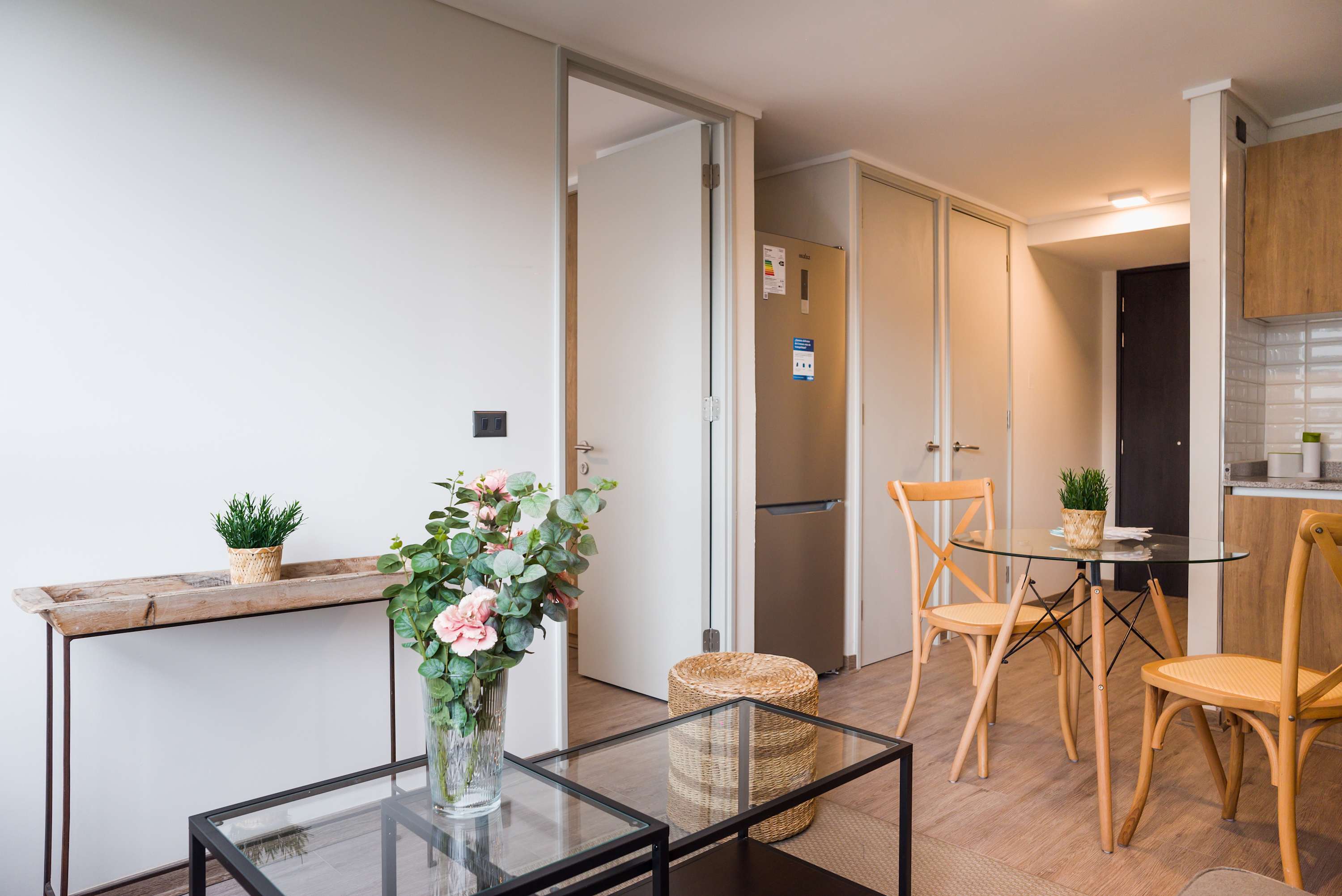 Bright and inviting living area with modern decor and a cozy dining space, perfect for a relaxing stay.