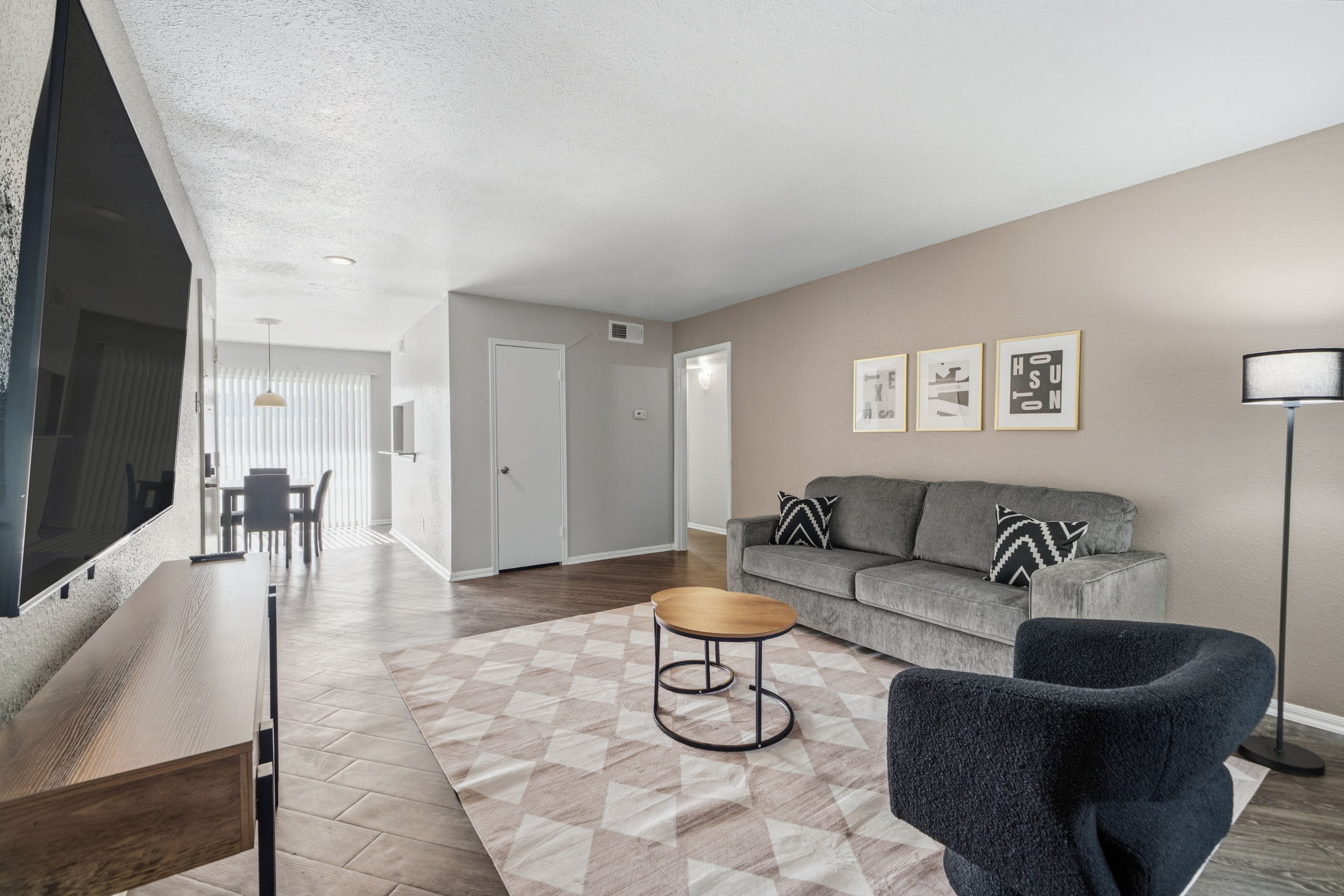 Spacious and modern living area with a large TV and stylish decor, perfect for relaxing after a day of exploring.