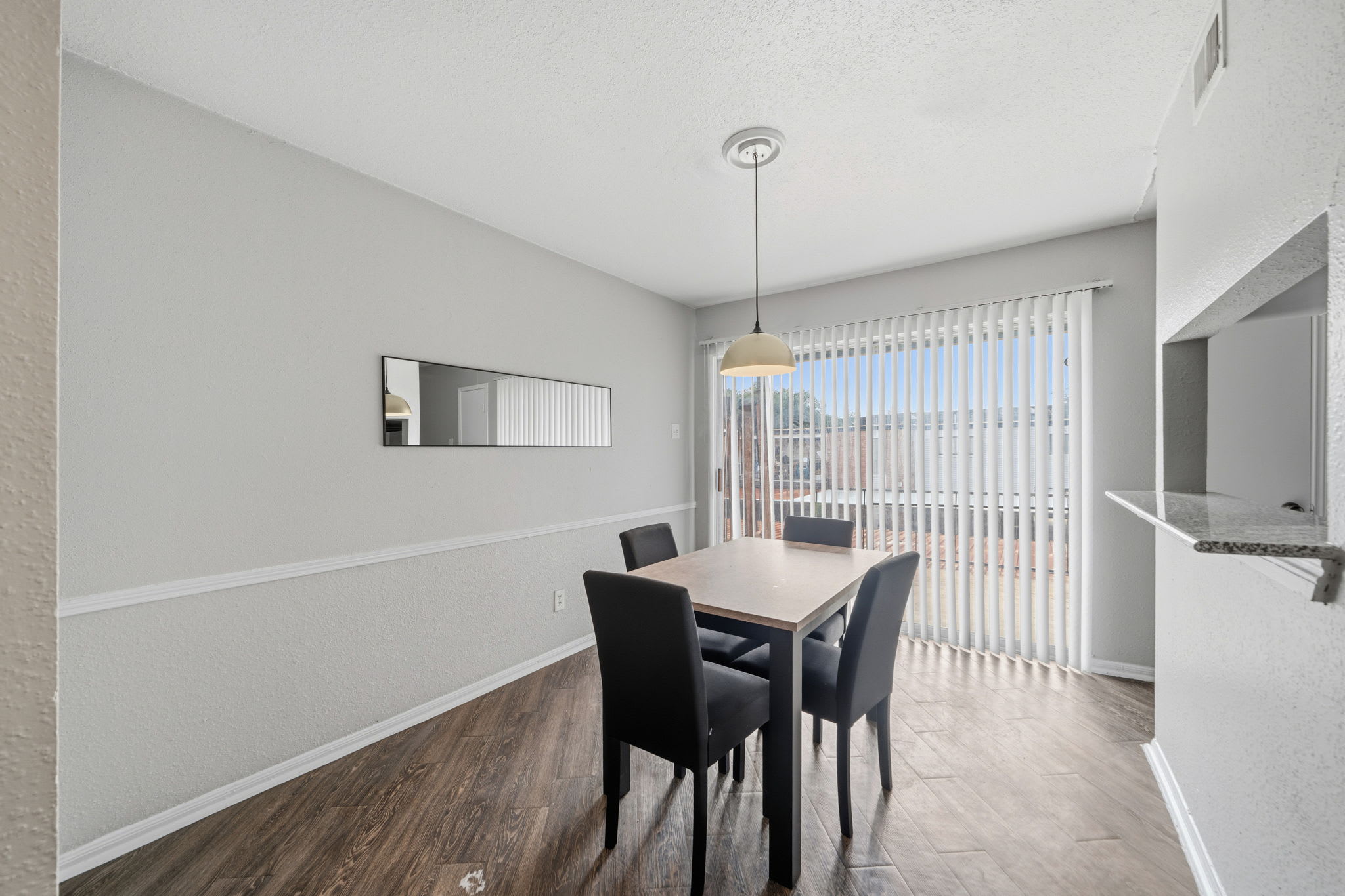 Bright dining area with modern furnishings and ample natural light, perfect for cozy meals.