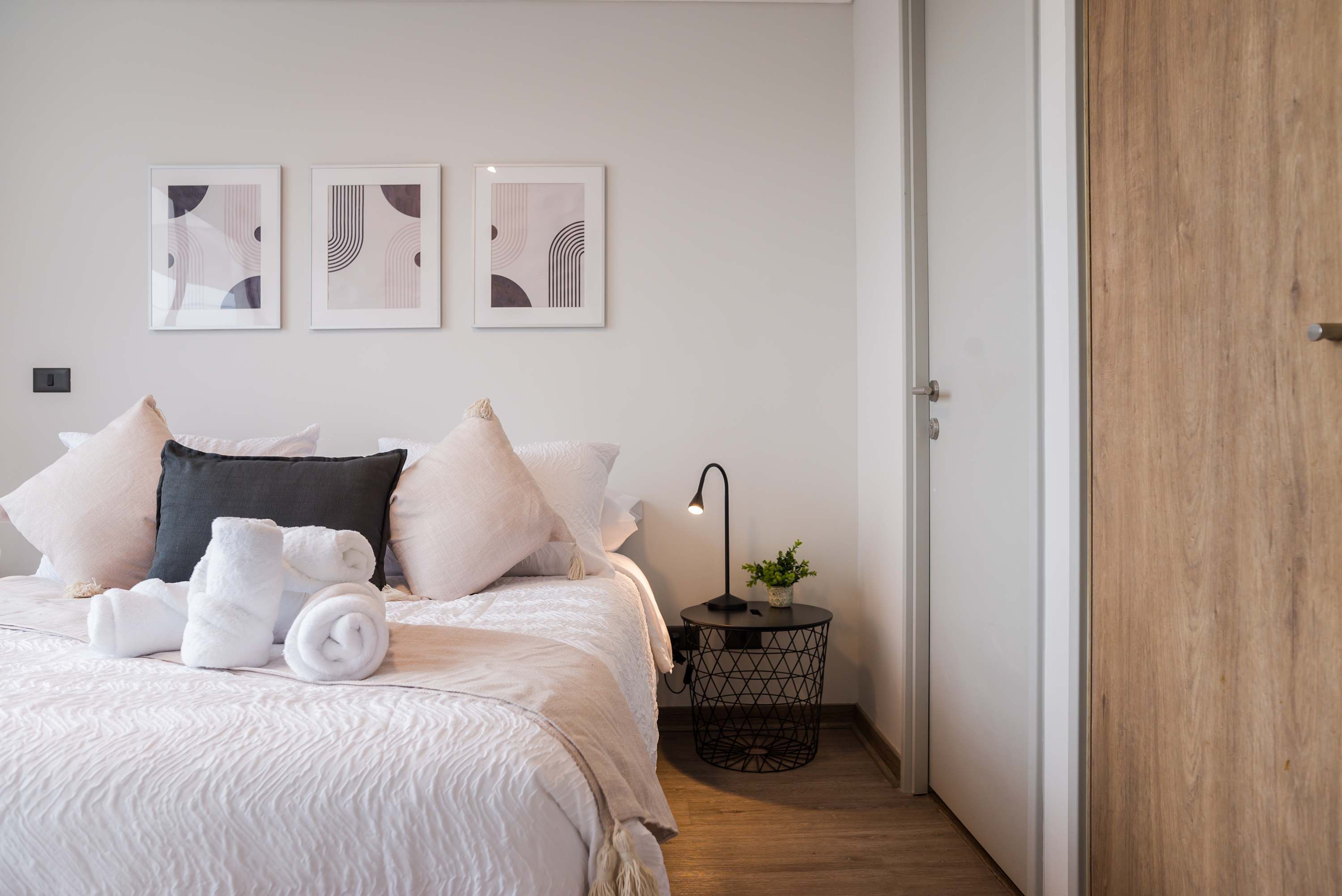 Relax in this stylish bedroom with modern decor and cozy bedding, perfect for unwinding after a day of exploring.