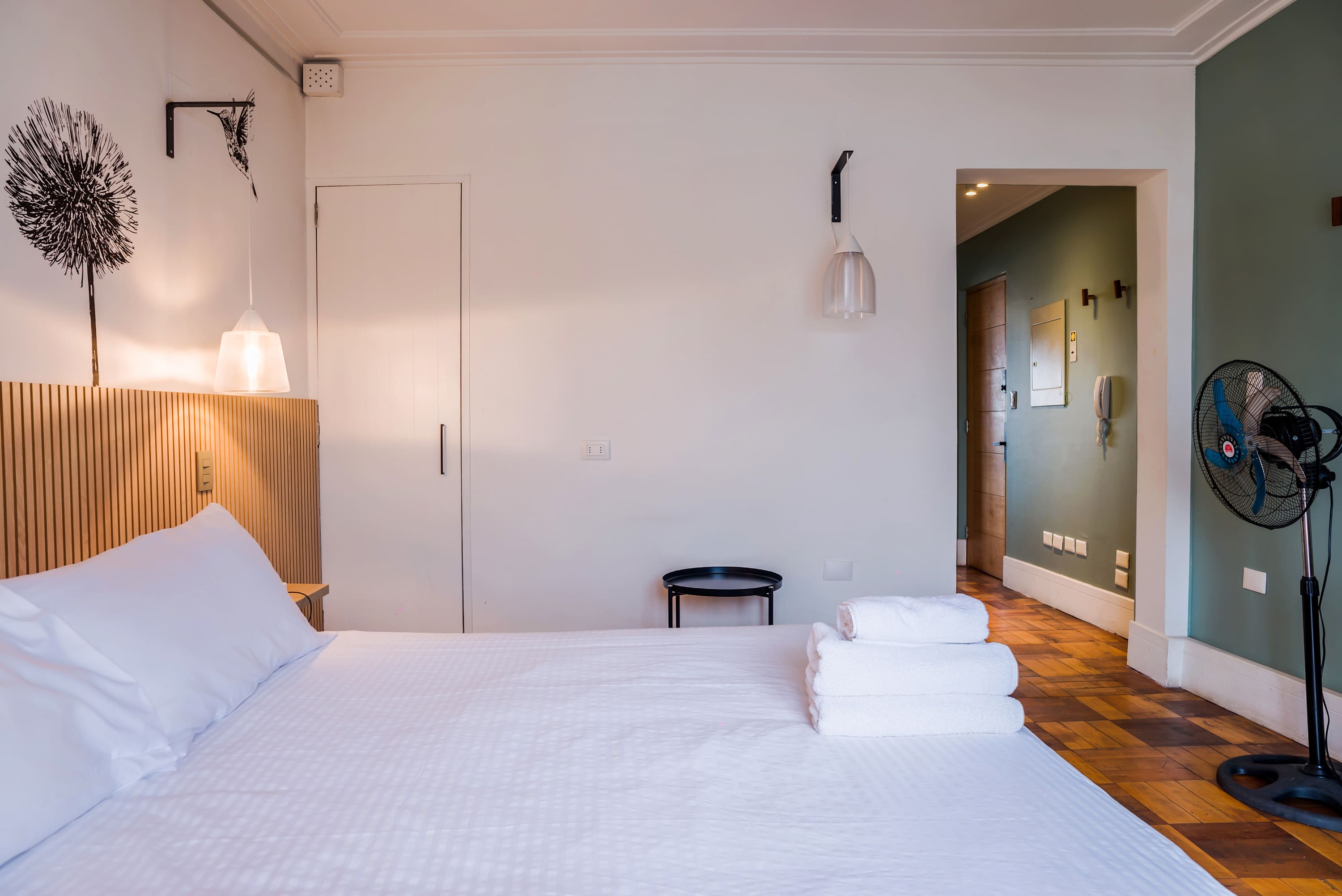 Relax in this cozy bedroom with modern decor and soft lighting, perfect for a restful stay in the heart of the city.