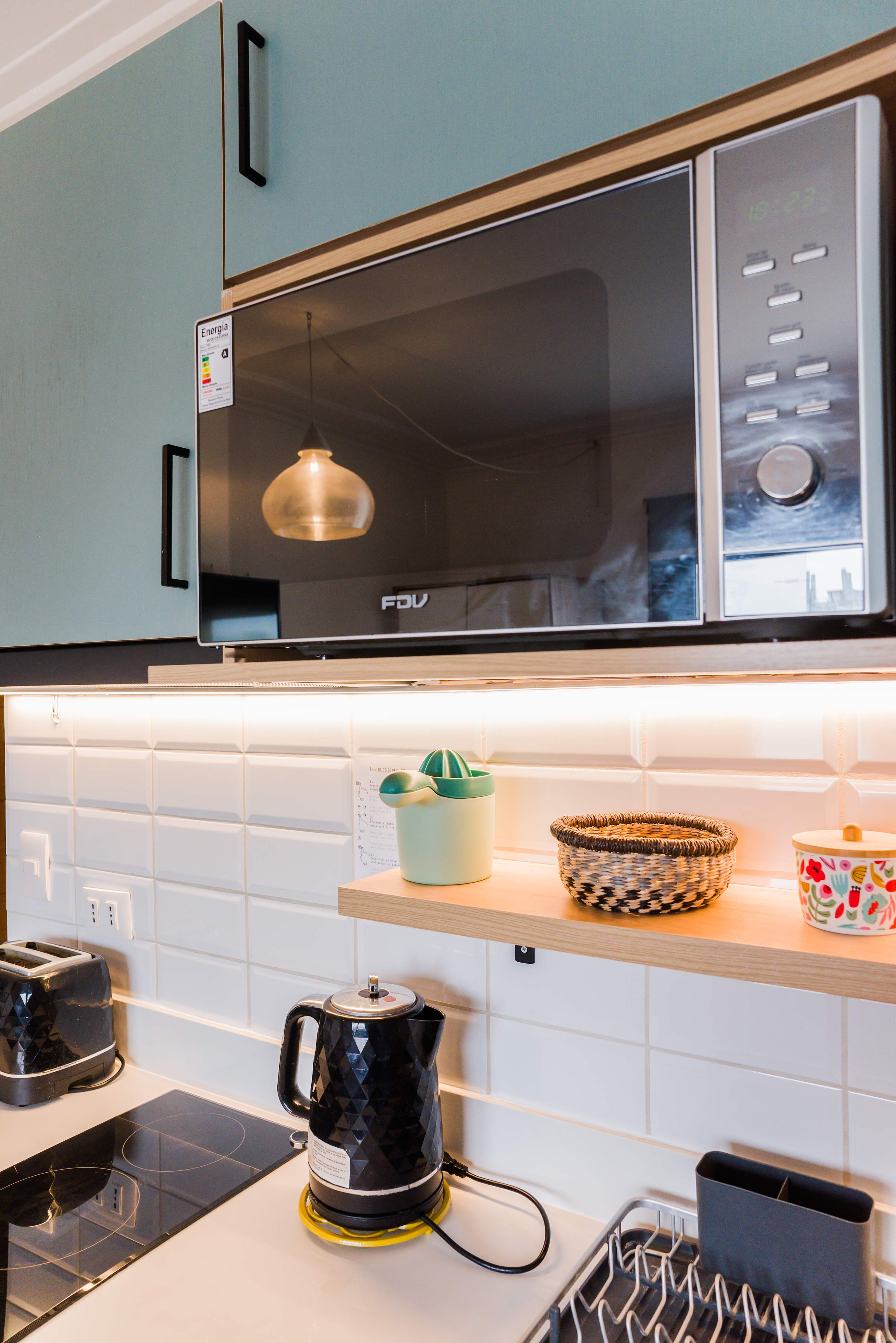 Modern kitchen with sleek appliances and stylish decor, perfect for cozy meals.