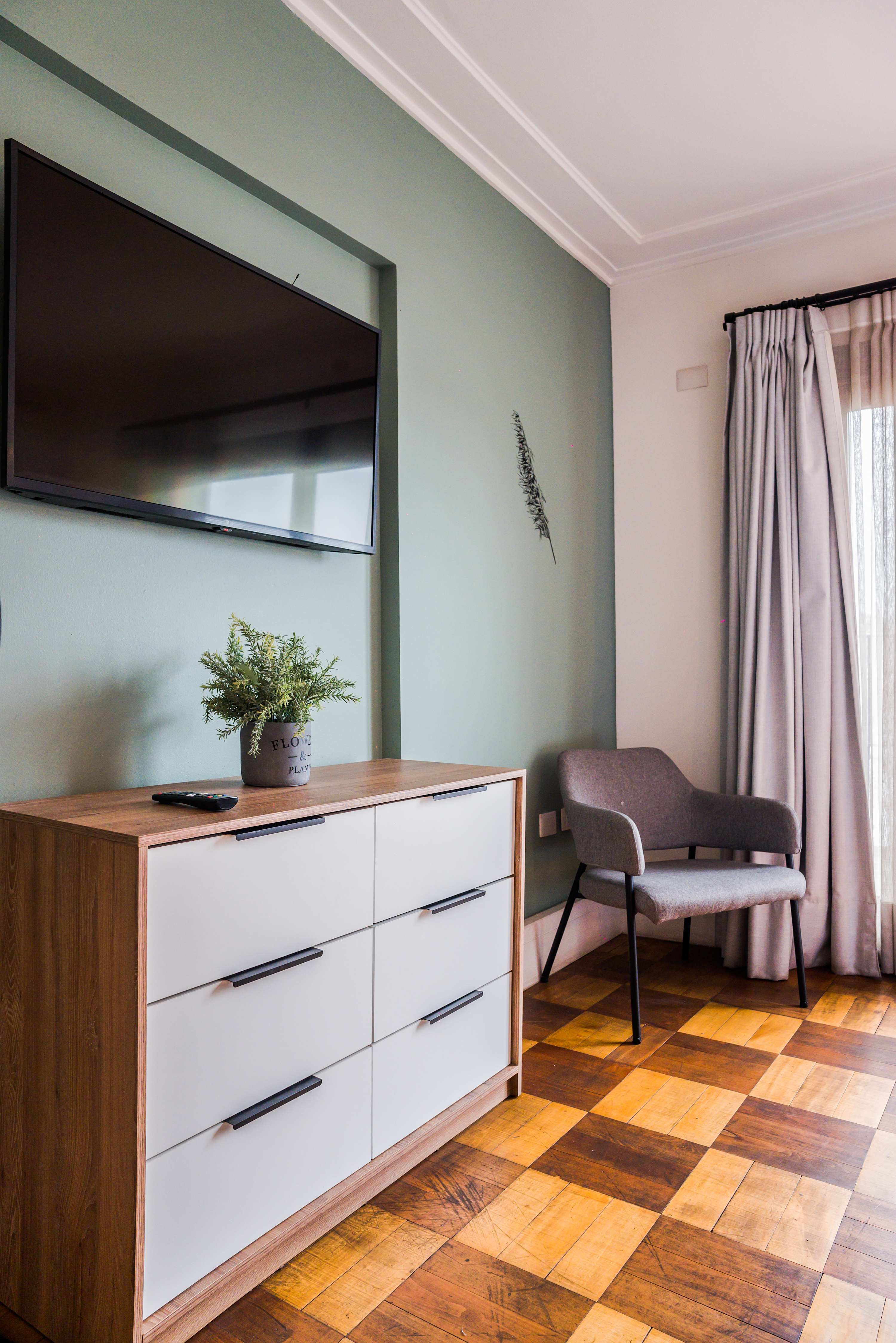 Relax in this stylish living area with a modern TV setup and comfortable seating, perfect for unwinding after a day of exploring.
