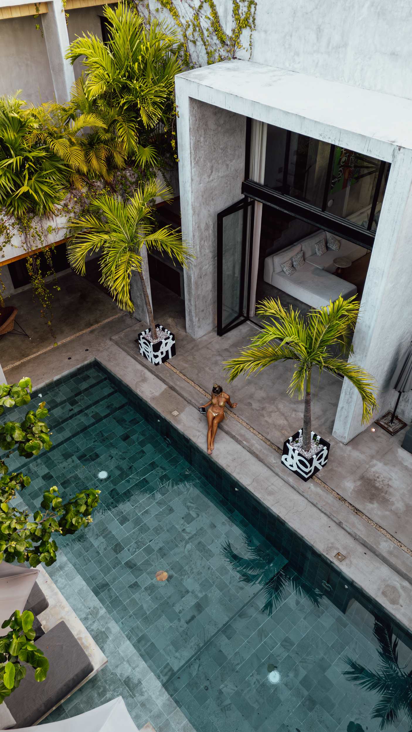 Drone view of the pool surrounded by lush gardens