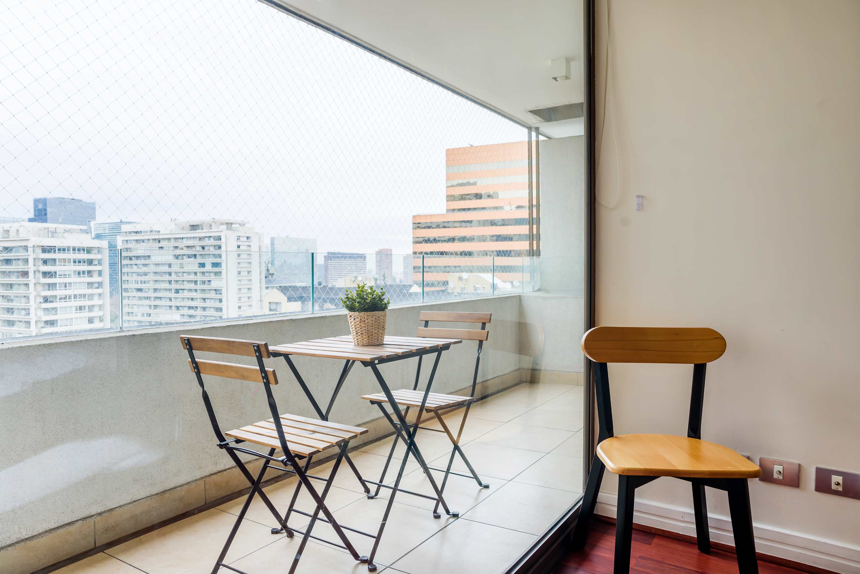 Enjoy a morning coffee with stunning city views from your private balcony in the heart of Santiago.