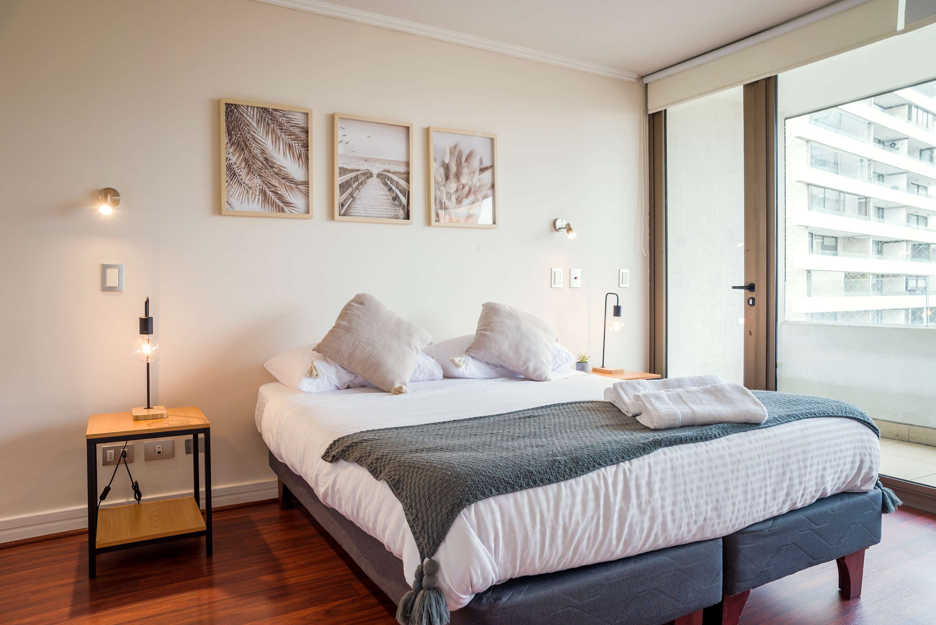 Relax in this cozy bedroom with a comfy bed and natural light from the balcony.