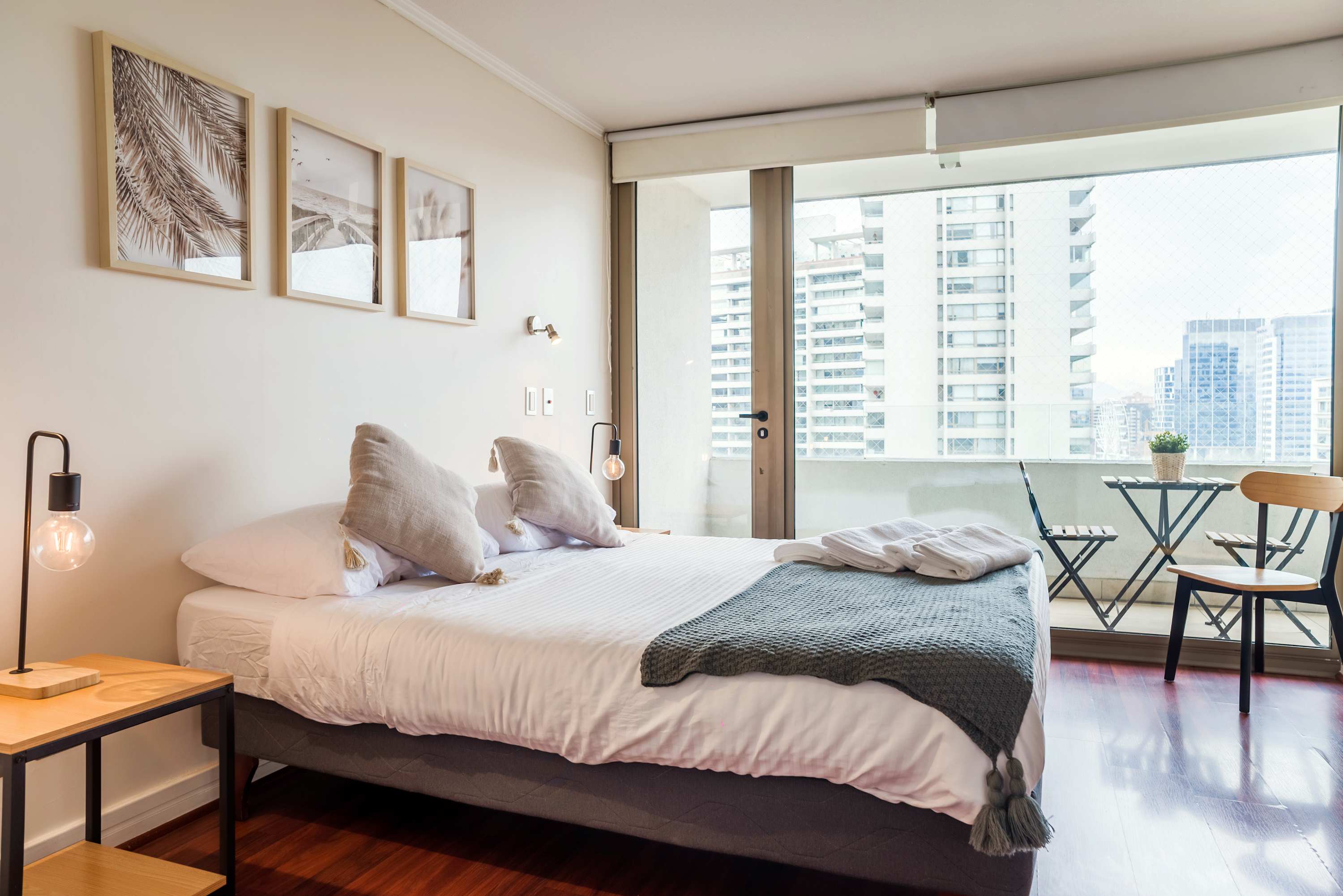 Cozy bedroom with balcony views, perfect for relaxing after exploring the city.