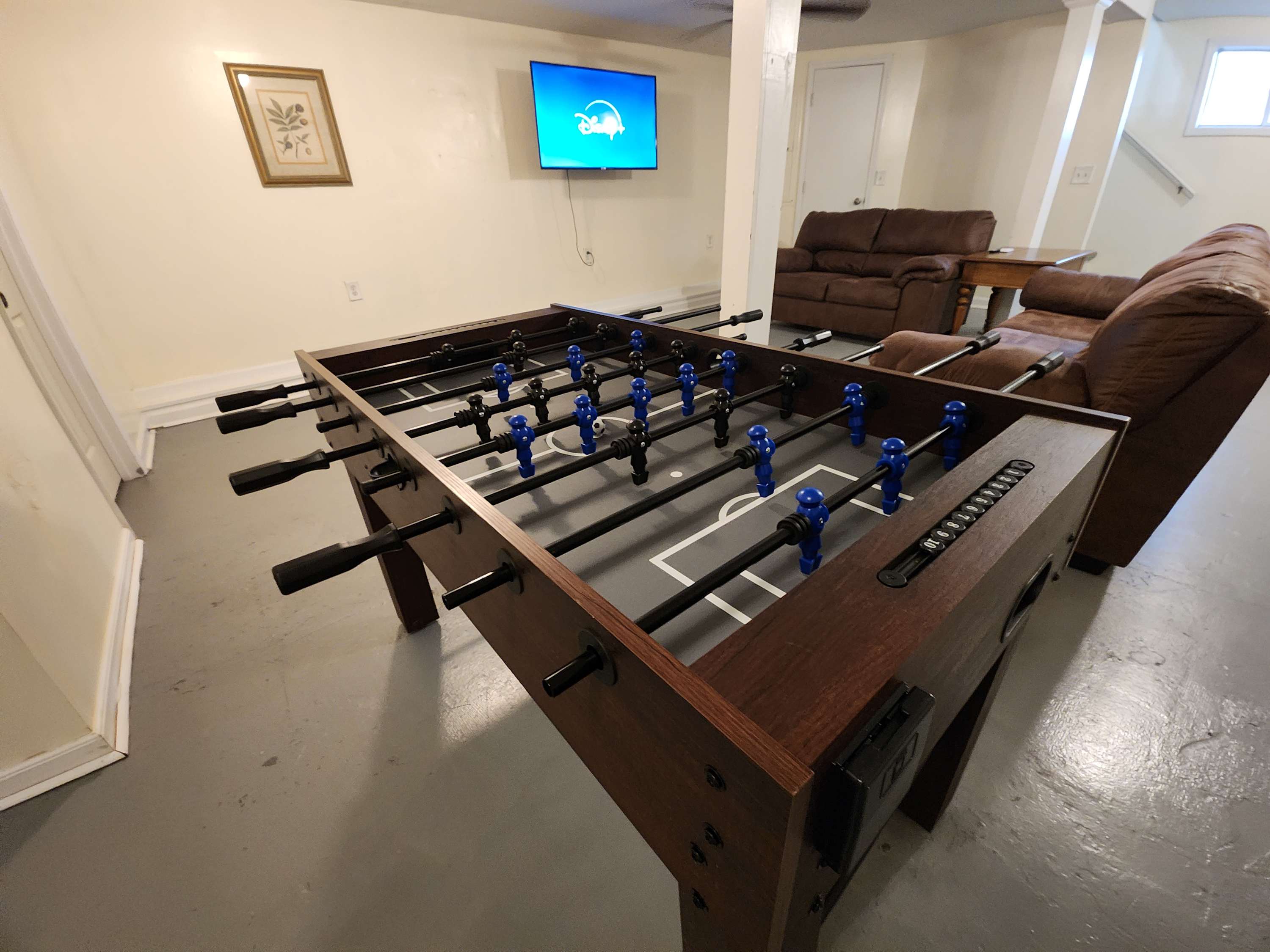 Foosball Table, TV, & 2 Couches in Basement