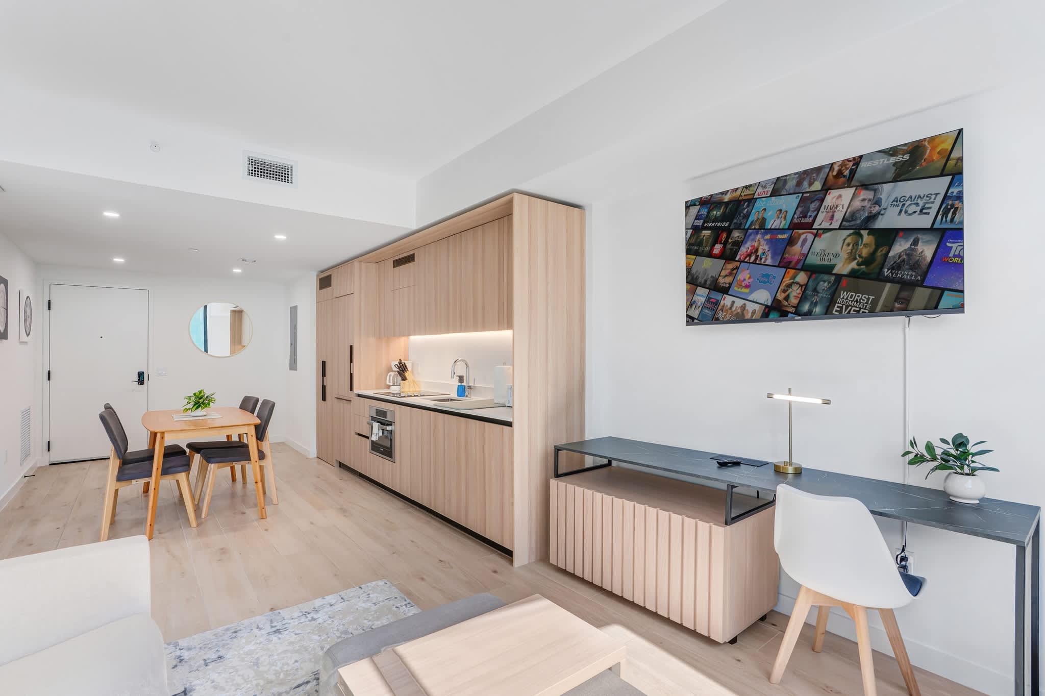Experience modern living in this stylish studio with a fully equipped kitchen, cozy dining area, and entertainment-ready TV setup.