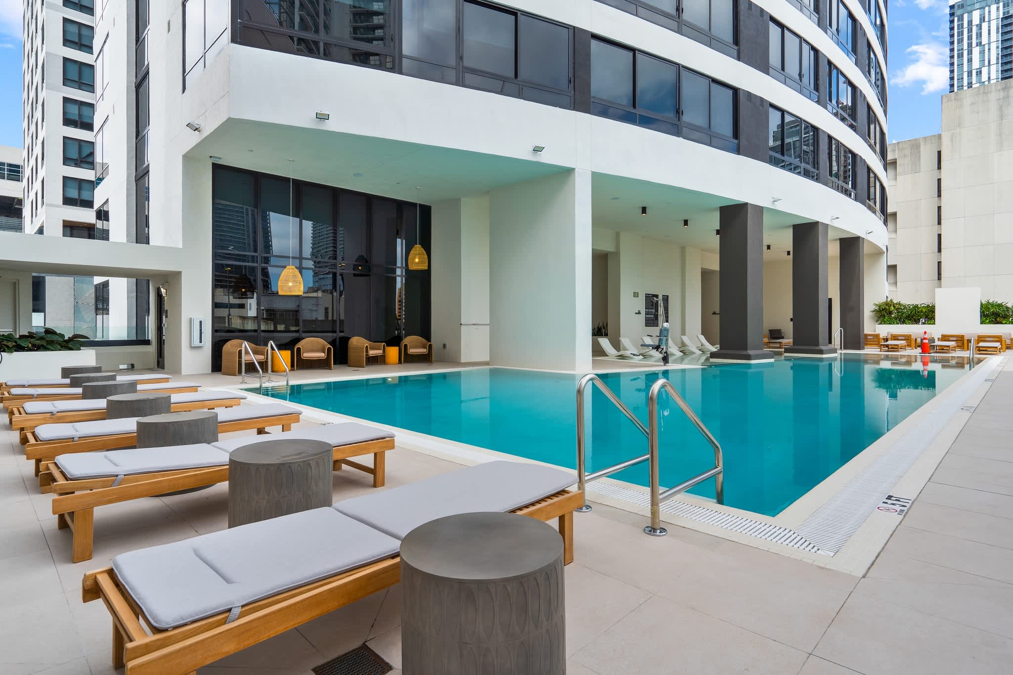 Relax by the sleek poolside with modern amenities and stunning city views, perfect for unwinding after a day of exploring.