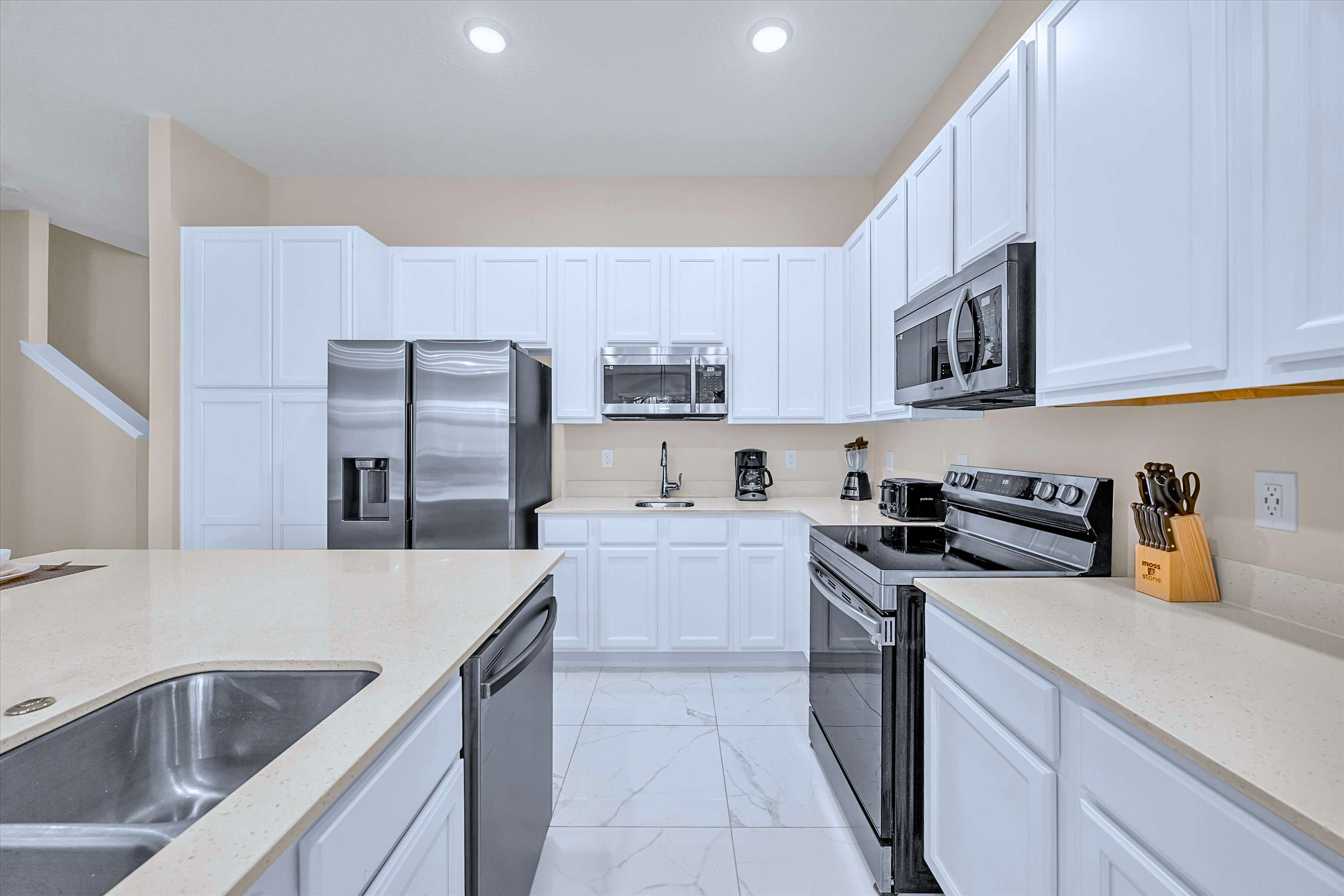 Fully Equipped Modern Kitchen – Sleek stainless-steel appliances, double fridges, and ample prep space.