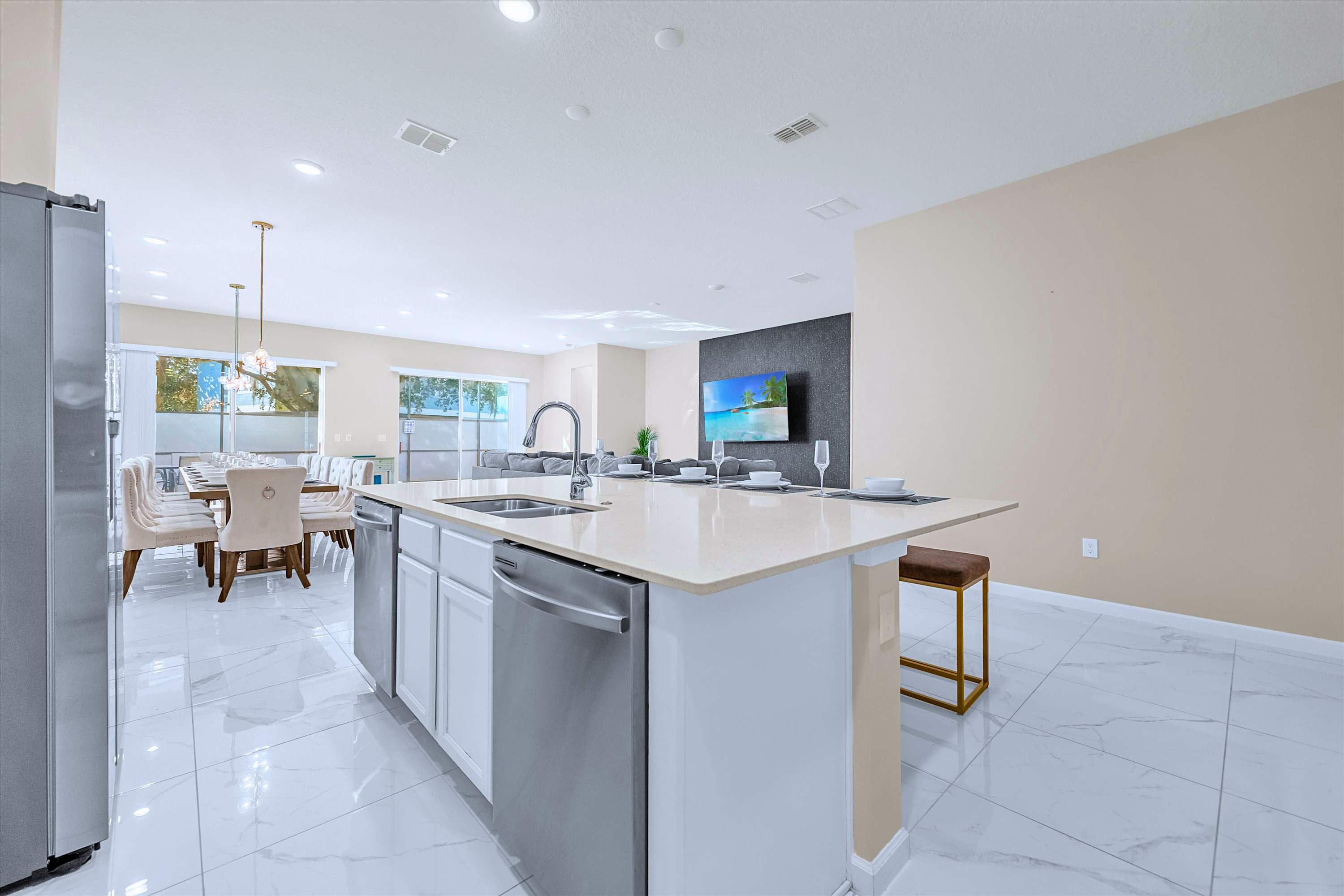 Fully Equipped Modern Kitchen – Sleek stainless-steel appliances, double fridges, and ample prep space.