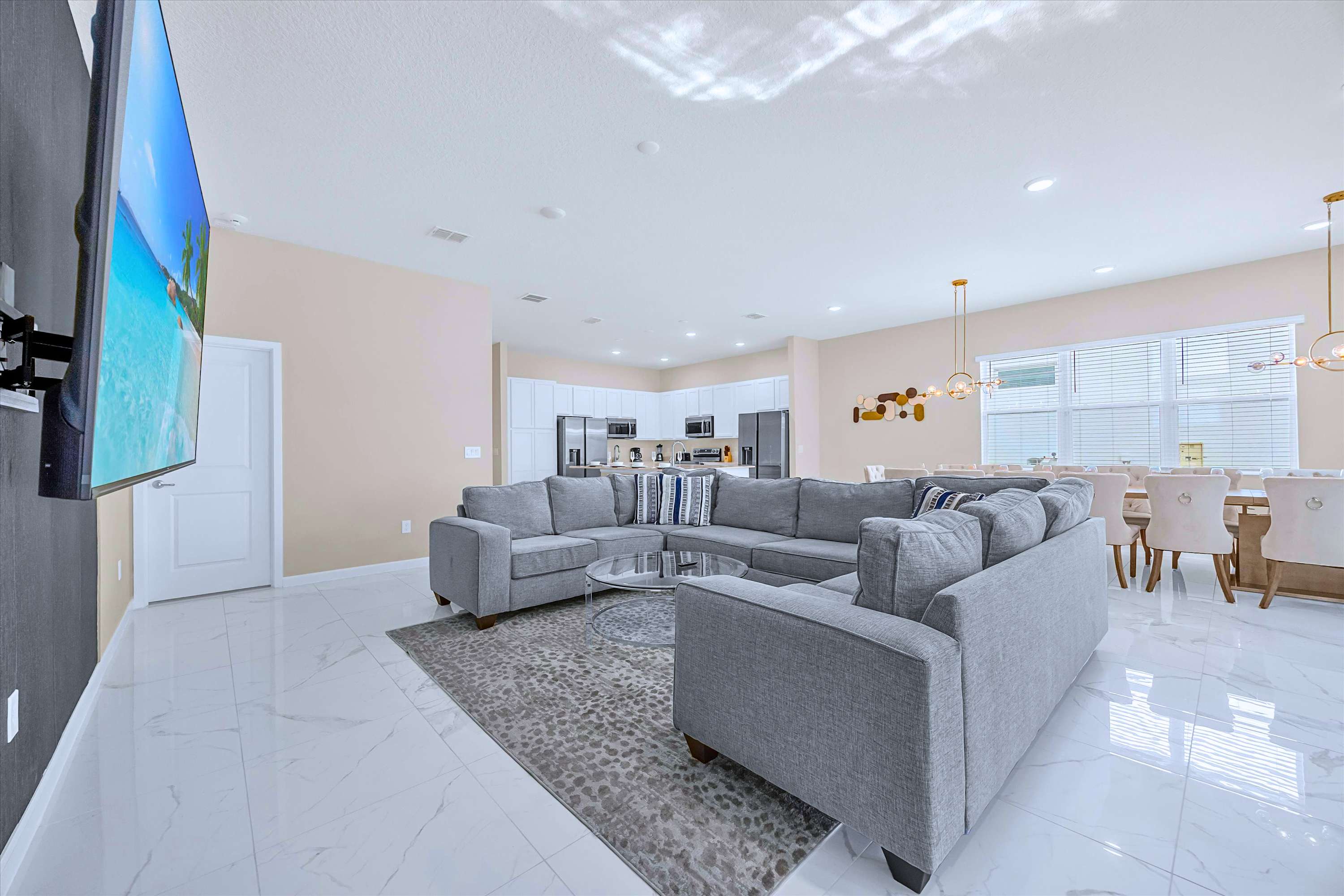 Spacious Living Room – Modern open-plan living area with plush seating and a large smart TV.