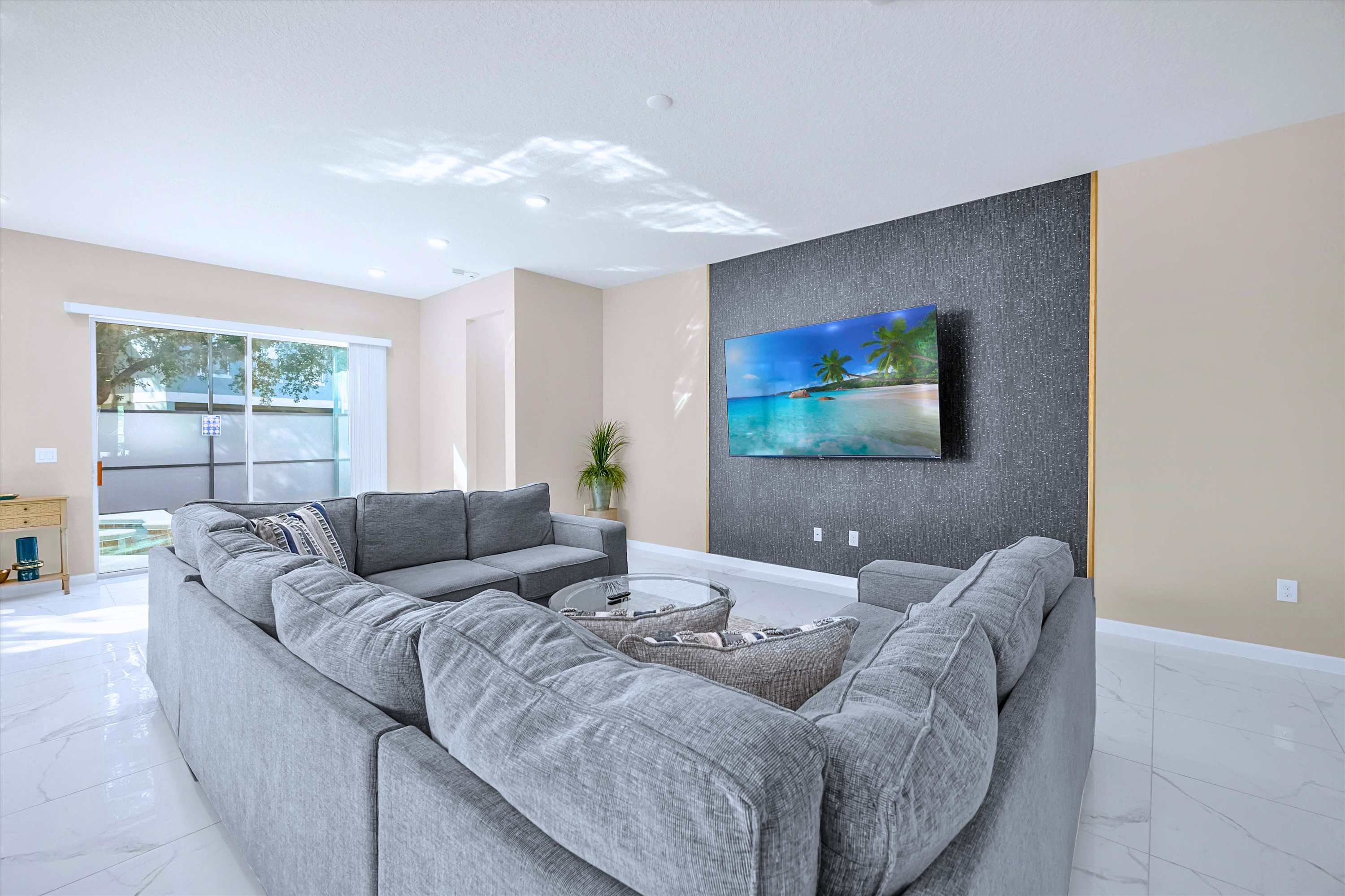 Spacious Living Room – Modern open-plan living area with plush seating and a large smart TV.