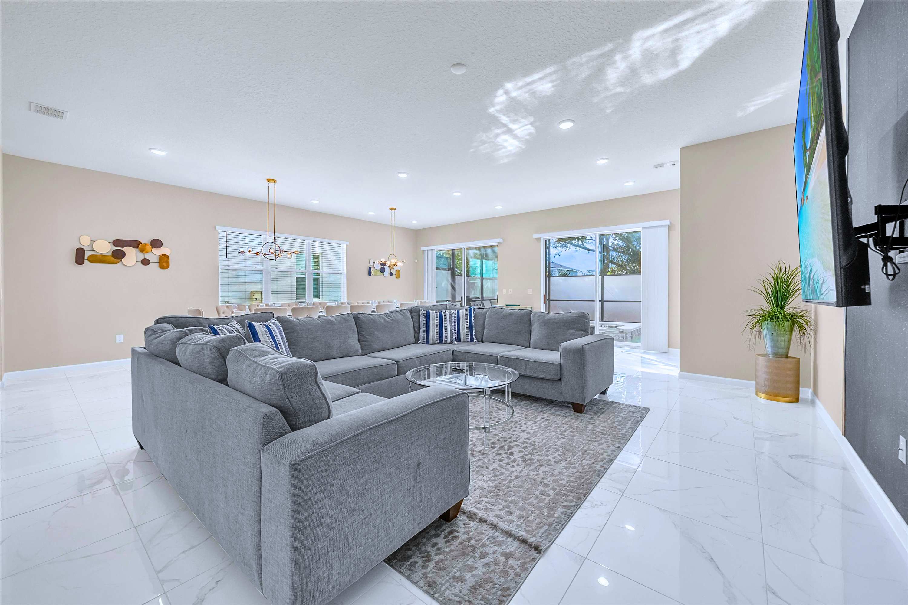 Spacious Living Room – Modern open-plan living area with plush seating and a large smart TV.