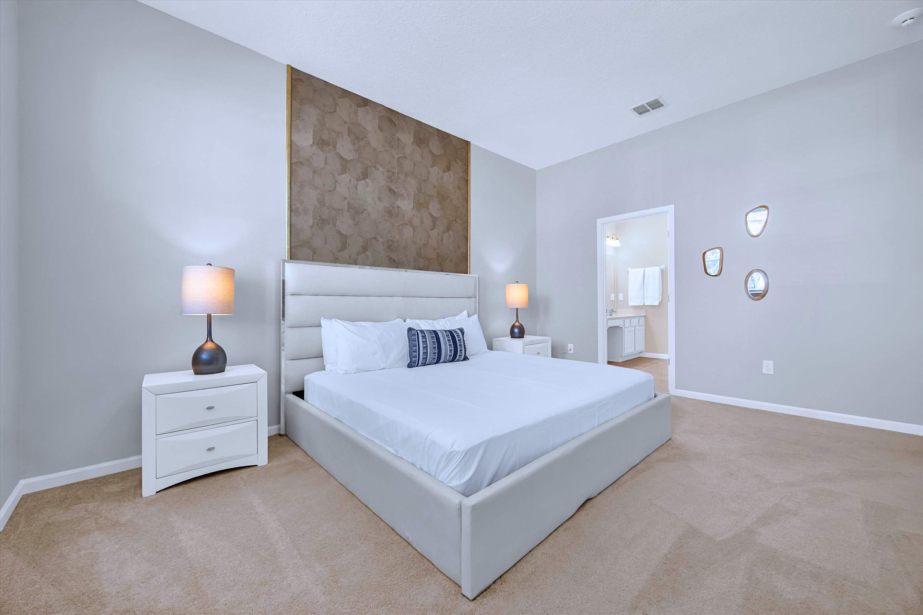 King Bed en-suite suite equipped with hotel bedding, bedside lamps, and private full bathroom