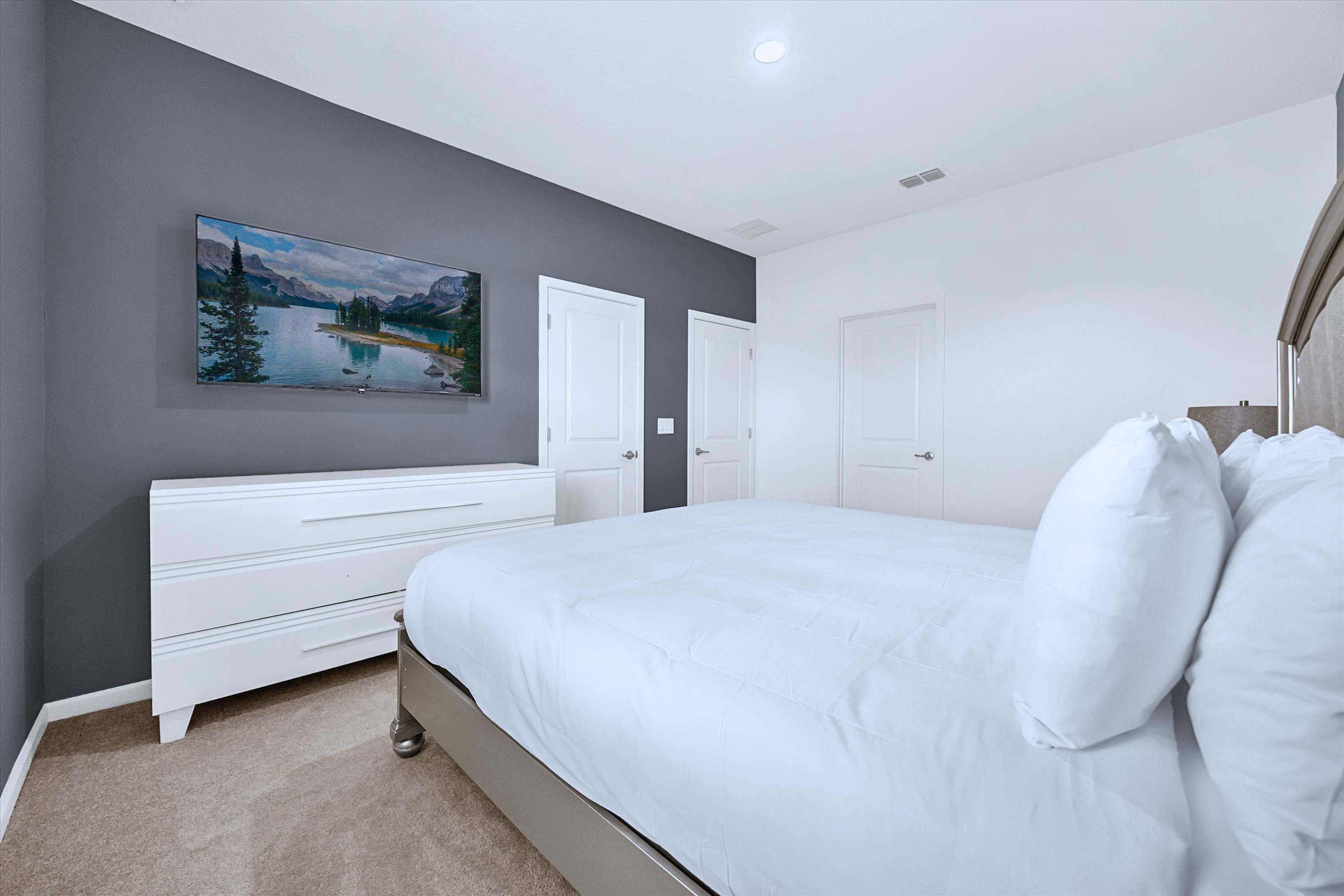 King Bed room with premium linens, TV media cabinet, and private en-suite bathroom