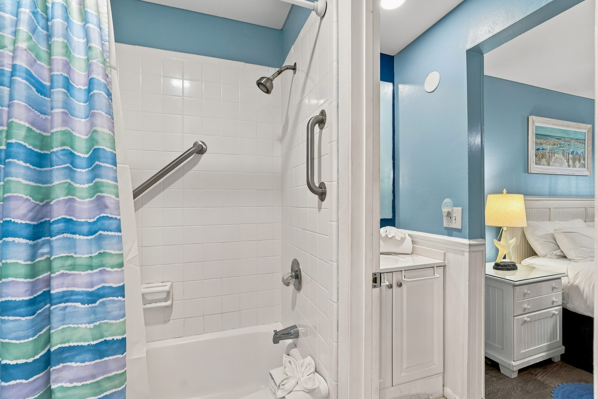 The Summit 308  – Bathroom with shower, colorful shower curtain, and a small vanity area visible in a vacation rental.